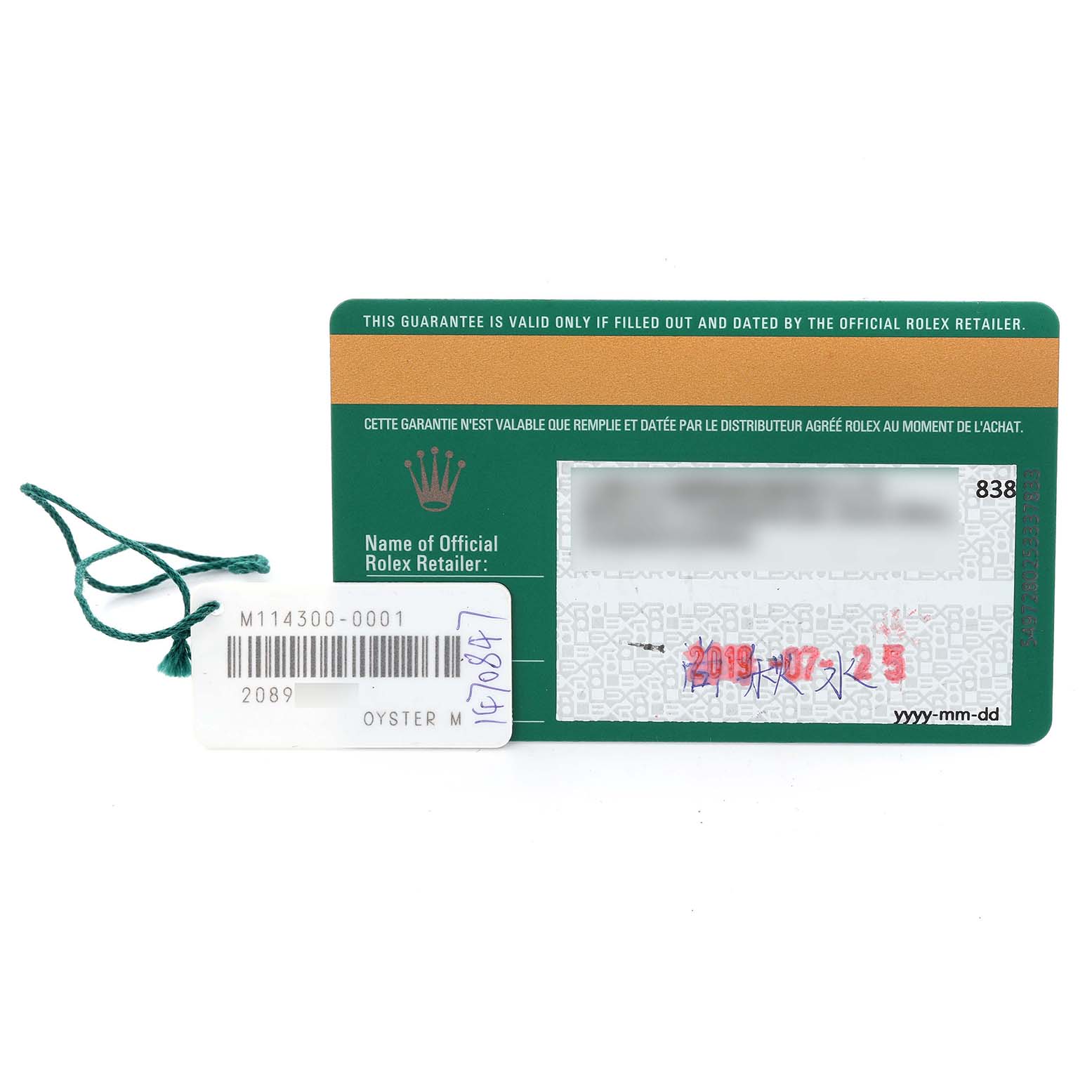 The image shows the warranty card and tag for a Rolex Oyster Perpetual 114300 Men's Stainless Steel Grey Dial 114300 Men's Stainless Steel Grey Dial model.