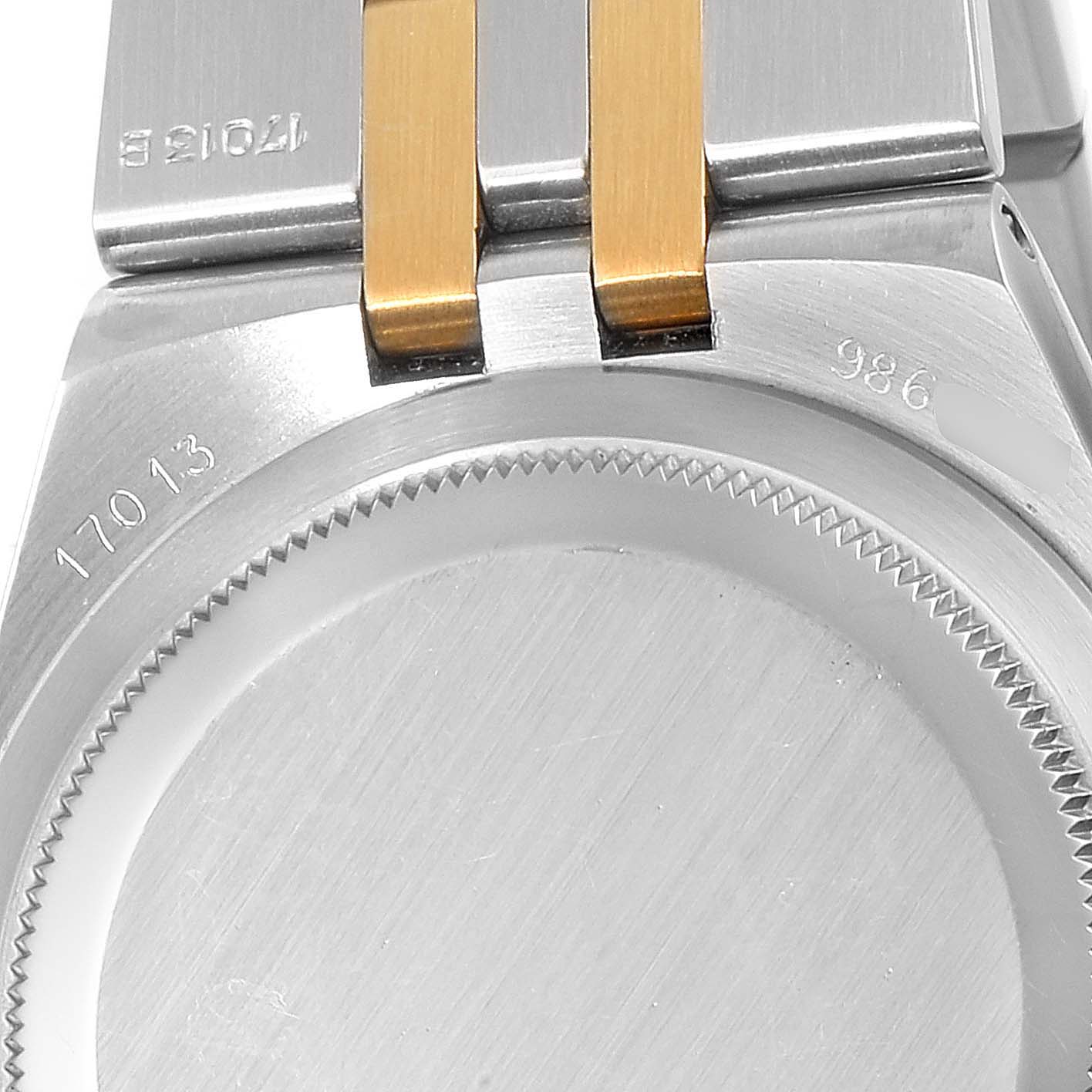The image shows the back case and part of the bracelet of the Rolex Oysterquartz 17013 Men's Steel and Gold (two tone) Champagne Dial 17013 Men's Steel and Gold (two tone) Champagne Dial model, highlighting the model number and serial number.