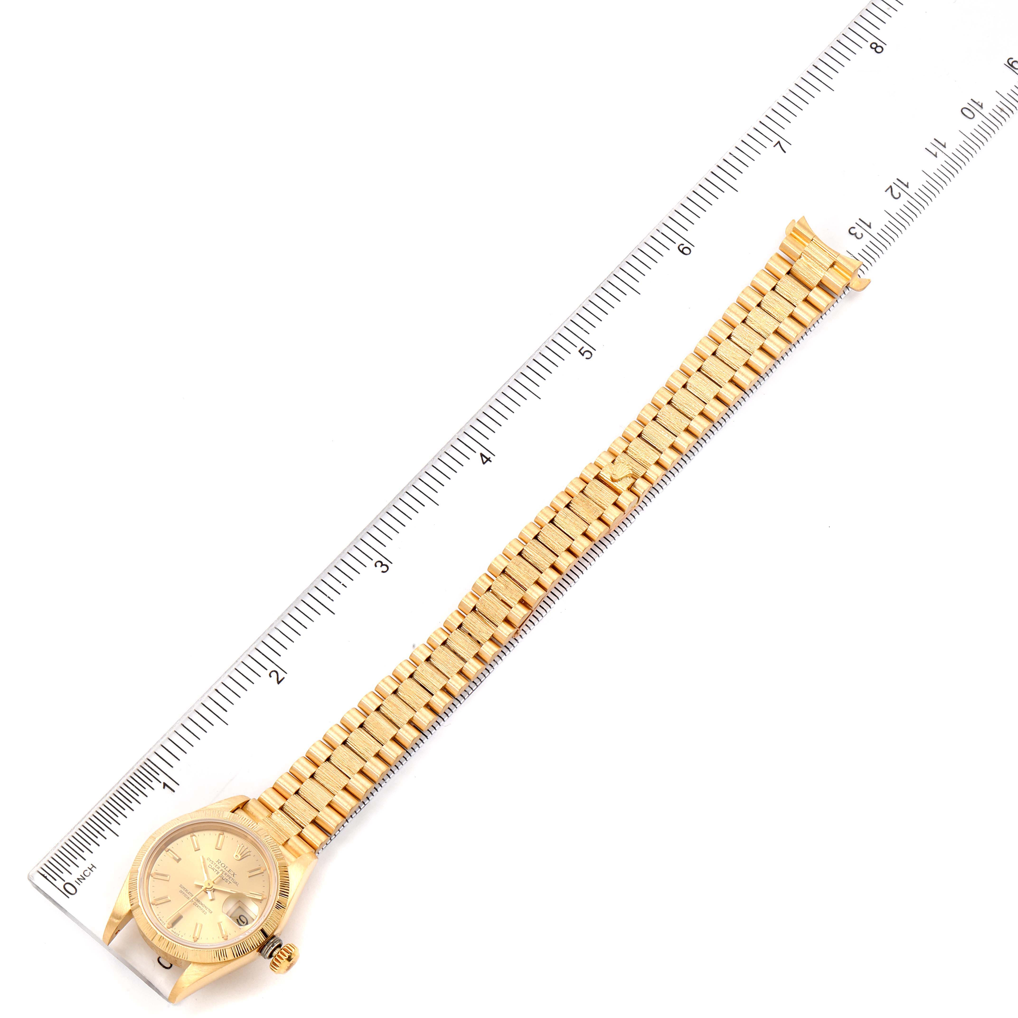 The image shows a top-down view of a Rolex President 69278 Women
s Yellow Gold Champagne Dial 69278 Women
s Yellow Gold Champagne Dial model watch with a ruler for scale.