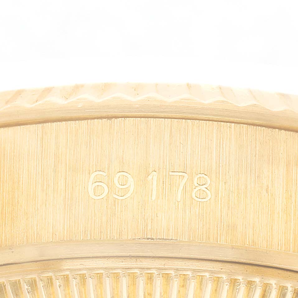 The image shows a close-up of the case side of a Rolex President 69178 Women's Yellow Gold Champagne Dial model, highlighting the engraved model number 69178.