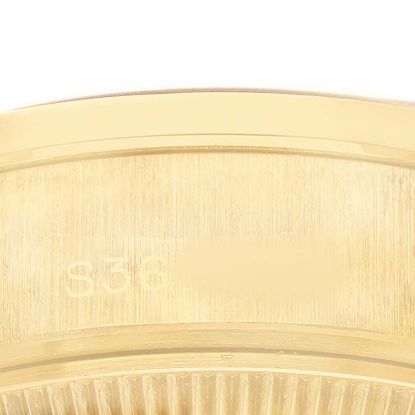 This close-up image shows the textured gold case and bezel details of a Rolex President 69068 Women's Yellow Gold Champagne Dial model watch.