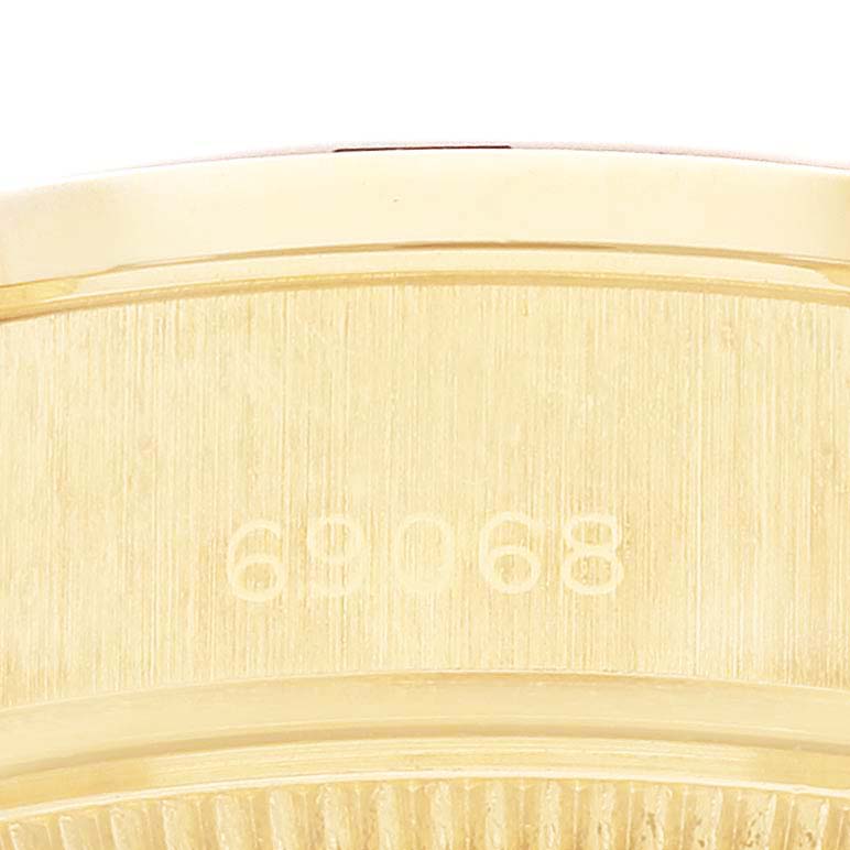 The image shows a close-up of the side of a Rolex President 69068 Women's Yellow Gold Champagne Dial model displaying its model number engraving.