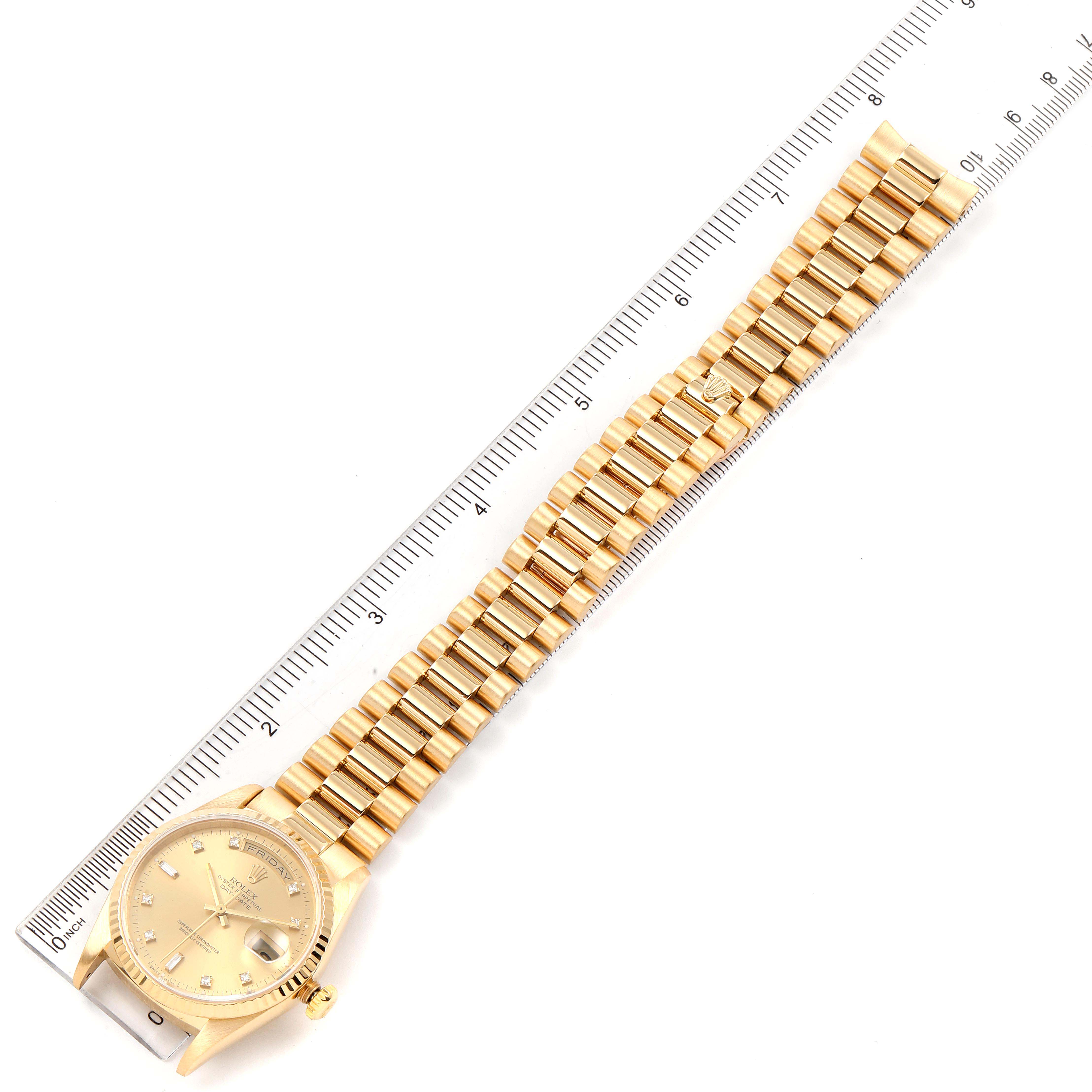 The image shows a Rolex President 18238 Men's Yellow Gold Champagne Dial 18238 Men's Yellow Gold Champagne Dial model watch laid flat next to a ruler, displaying its face and full bracelet.