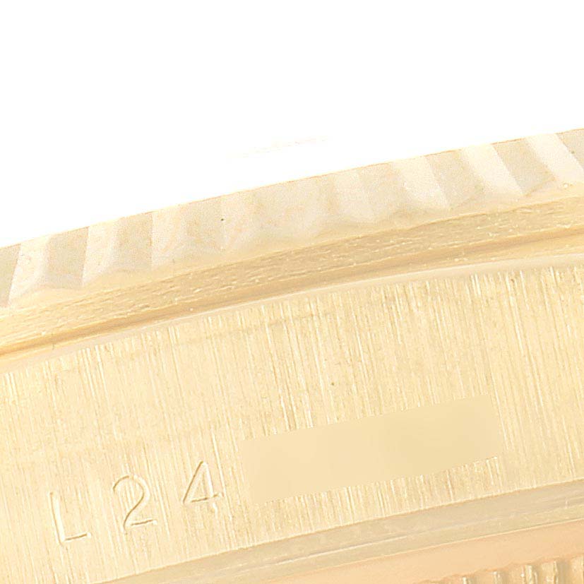 This image shows a close-up of the side case with engravings on a Rolex President 18238 Men's Yellow Gold Champagne Dial 18238 Men's Yellow Gold Champagne Dial model watch.