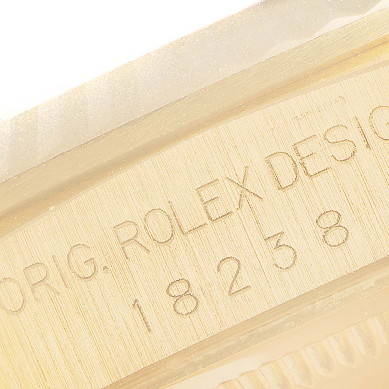 This image shows a close-up of the model and brand engraving on a Rolex President 18238 Men's Yellow Gold Champagne Dial 18238 Men's Yellow Gold Champagne Dial watch.