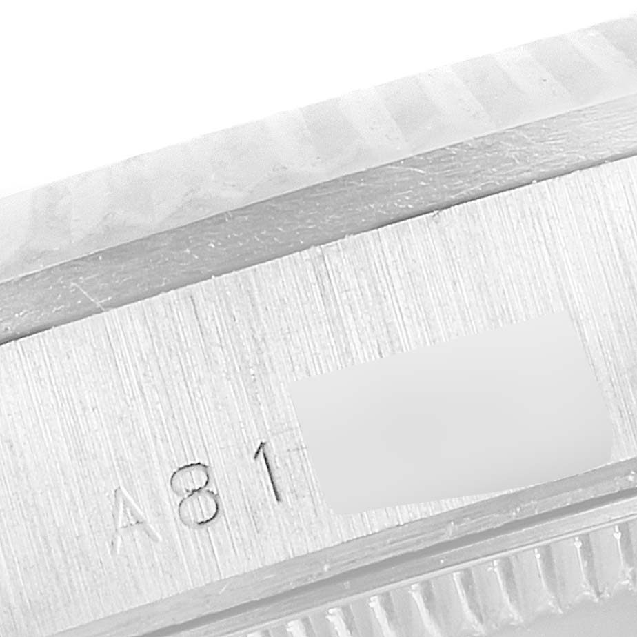 The image shows an extreme close-up of the side of a Rolex President 78279 Women's White Gold Silver Dial 78279 Women's White Gold Silver Dial model, highlighting the serial number engraving and the edge of the bezel.