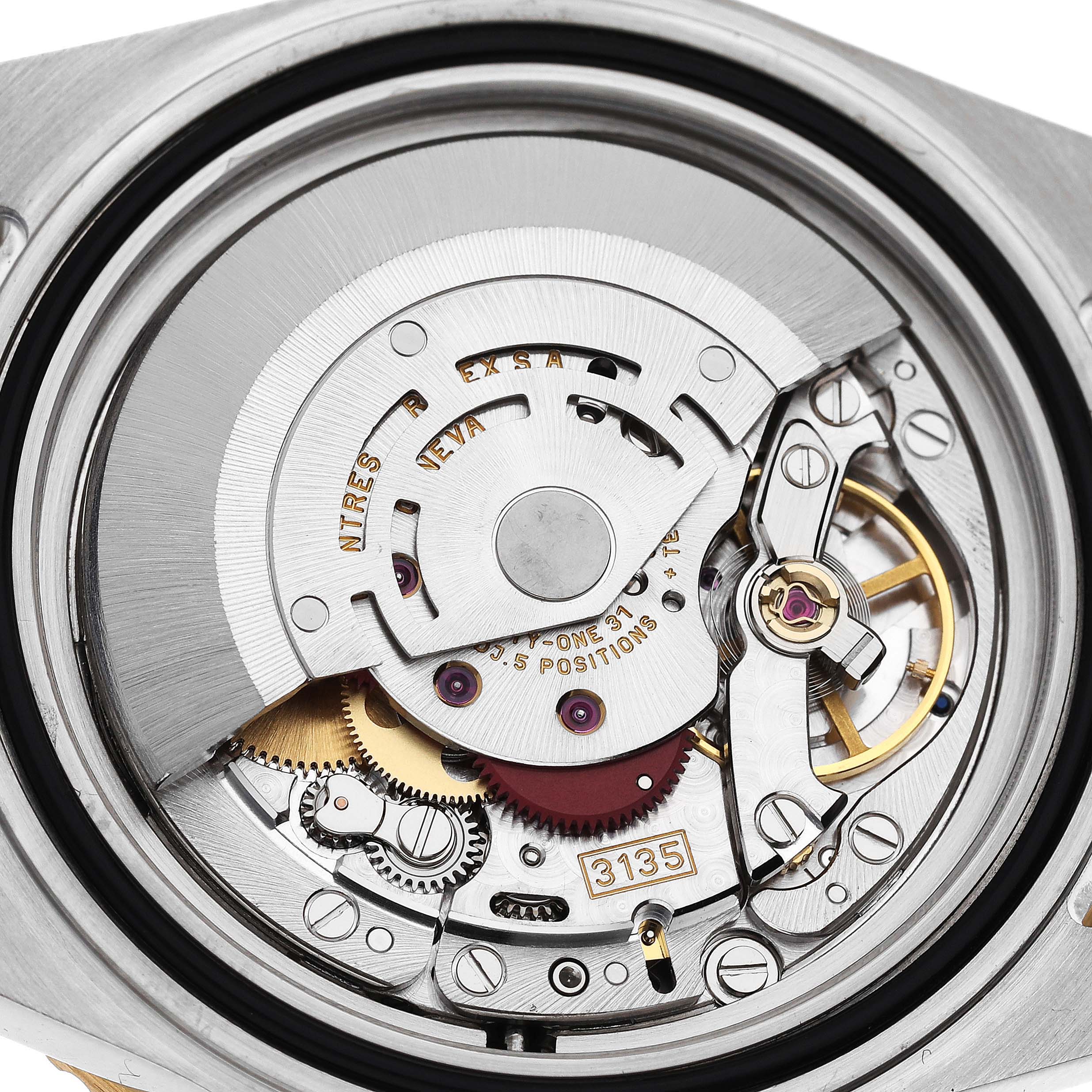 The image shows the intricate internal movement of a Rolex Submariner 16613 Men's Steel and Gold (two tone) Blue Dial 16613 Men's Steel and Gold (two tone) Blue Dial from a close-up, underside view.