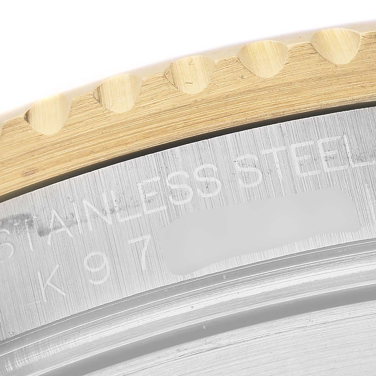 The image shows a close-up of the bezel and serial number area on a Rolex Submariner 16613 Men's Steel and Gold (two tone) Blue Dial 16613 Men's Steel and Gold (two tone) Blue Dial.