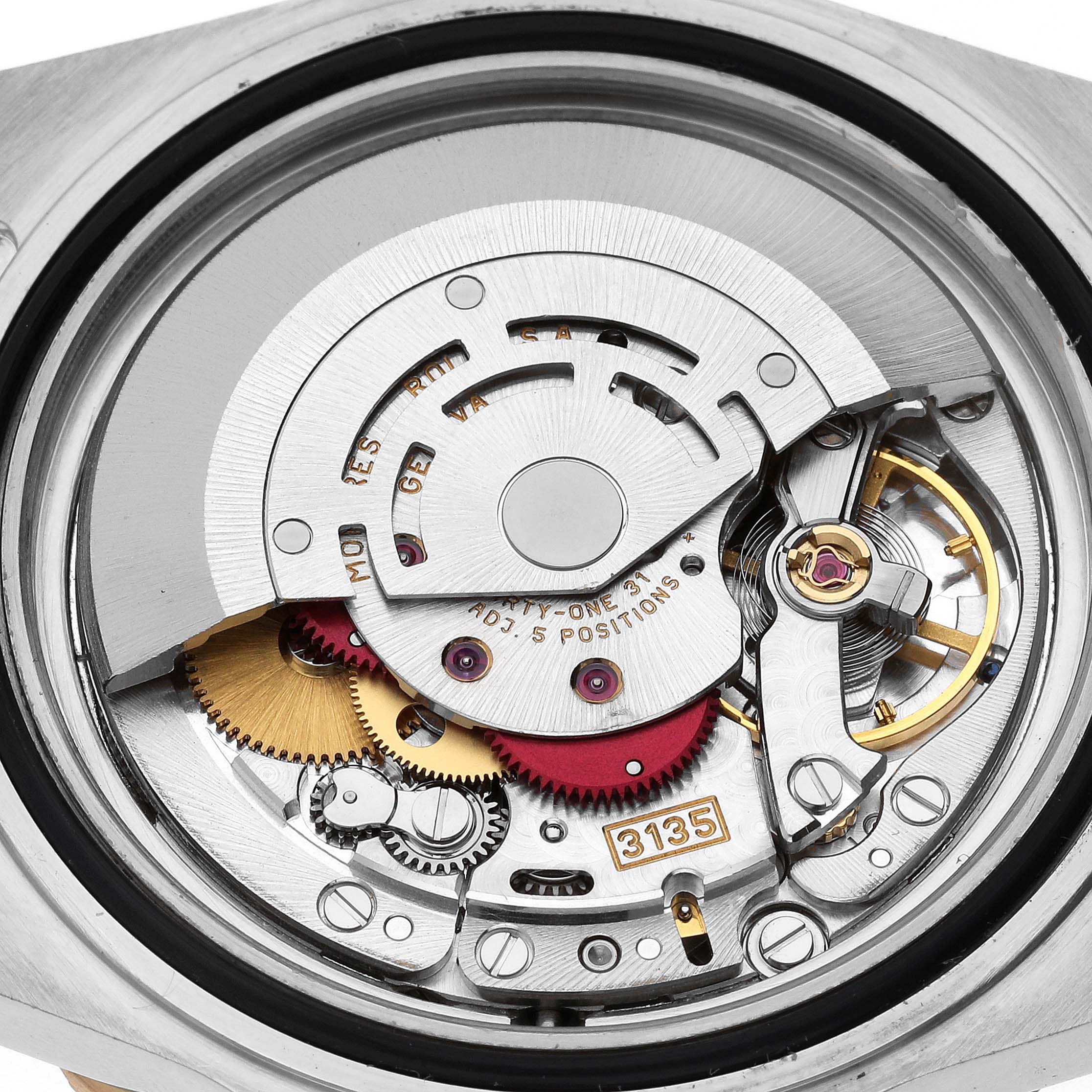 This image shows a close-up view of the inner mechanical movement of a Rolex Submariner 16613LB Men's Steel and Gold (two tone) Champagne Dial 16613LB Men's Steel and Gold (two tone) Champagne Dial watch, showcasing gears and intricate components.