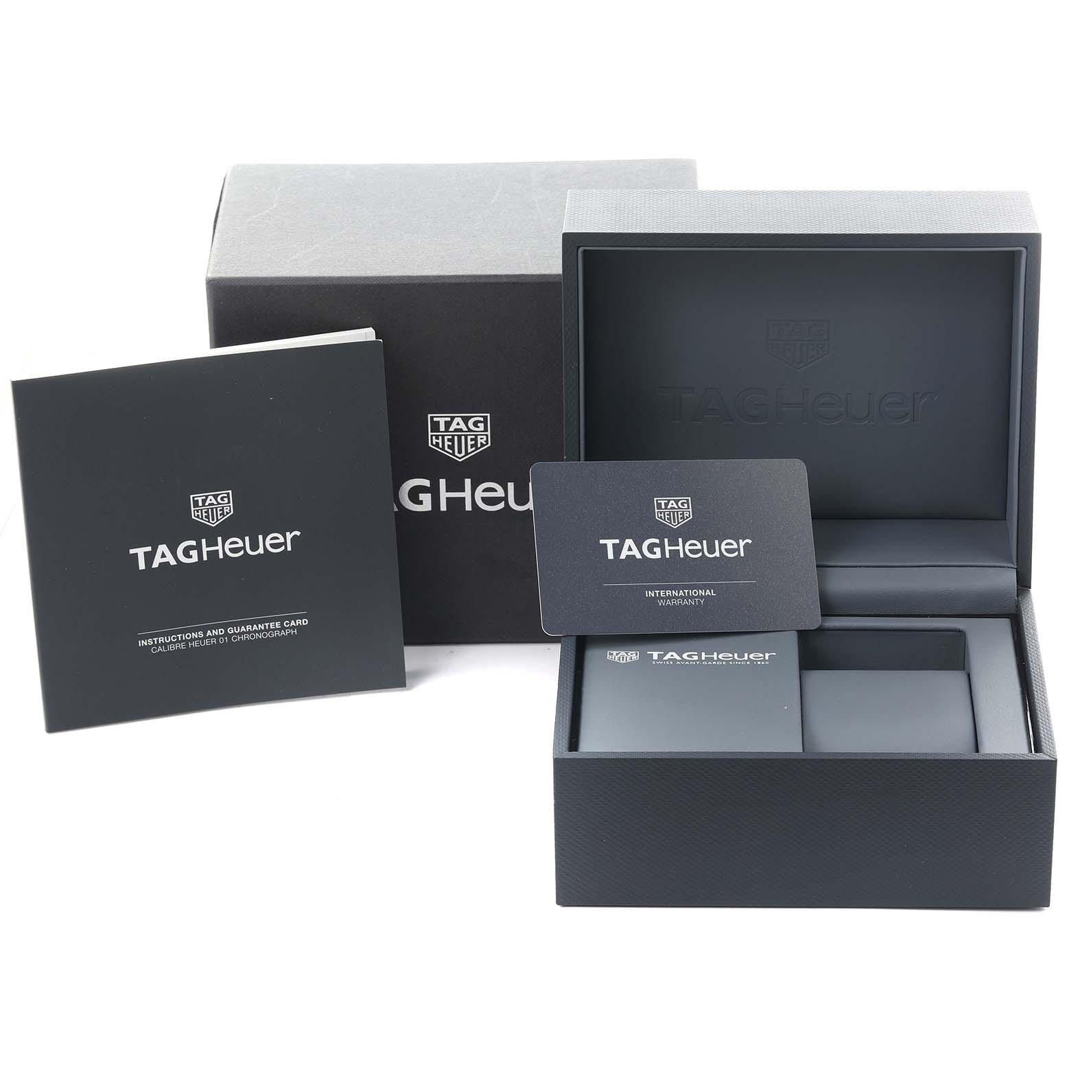 This image shows the packaging and accessories for a Tag Heuer Carrera CAR2A1Z.FT6044 Men's Stainless Steel Transparent Dial CAR2A1Z.FT6044 Men's Stainless Steel Transparent Dial, including the box, warranty card, and instruction booklet.