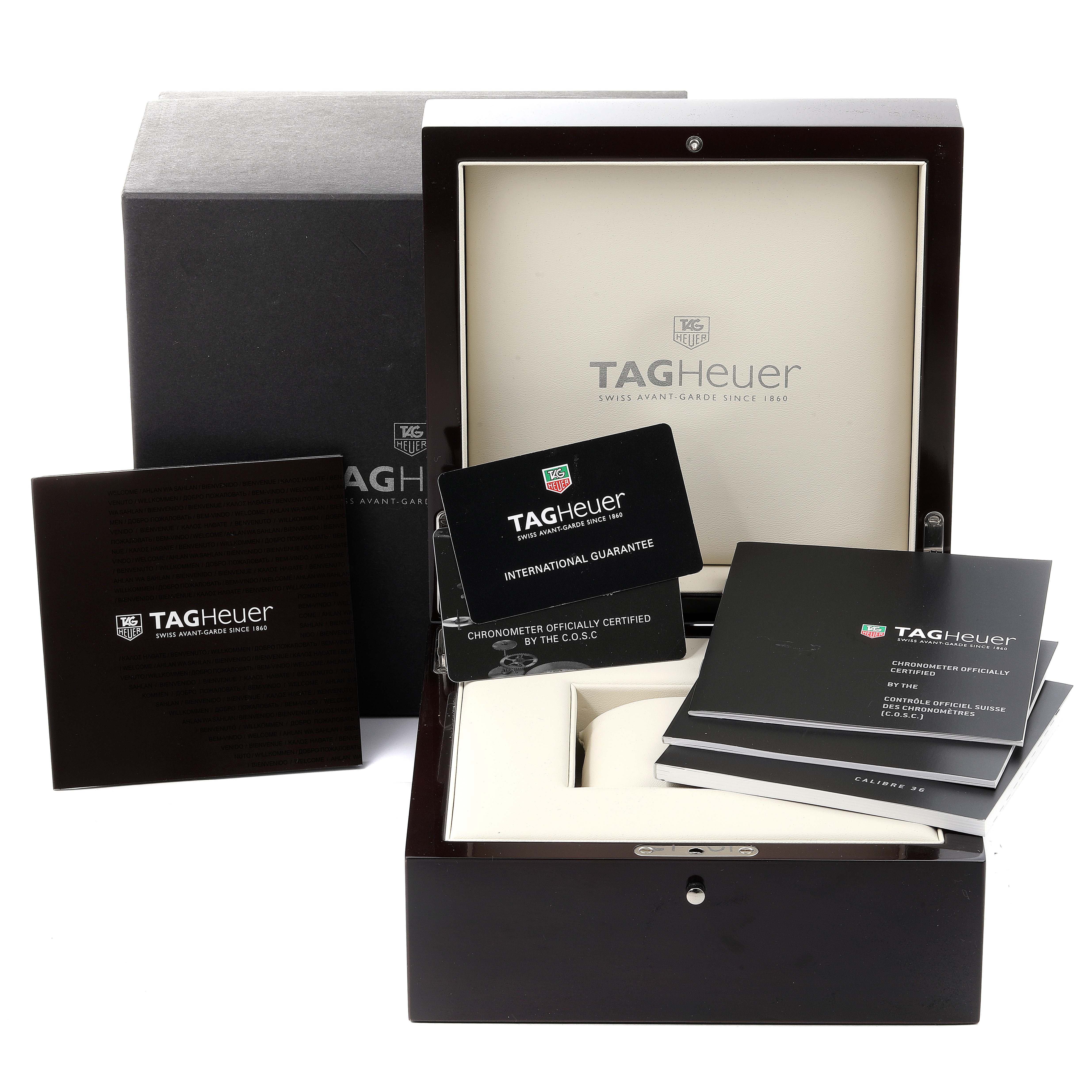 The image shows the open box and accessories of a Tag Heuer Carrera CAV5186.FC6304 Men's Titanium Black Dial CAV5186.FC6304 Men's Titanium Black Dial watch, including manuals and guarantee cards.