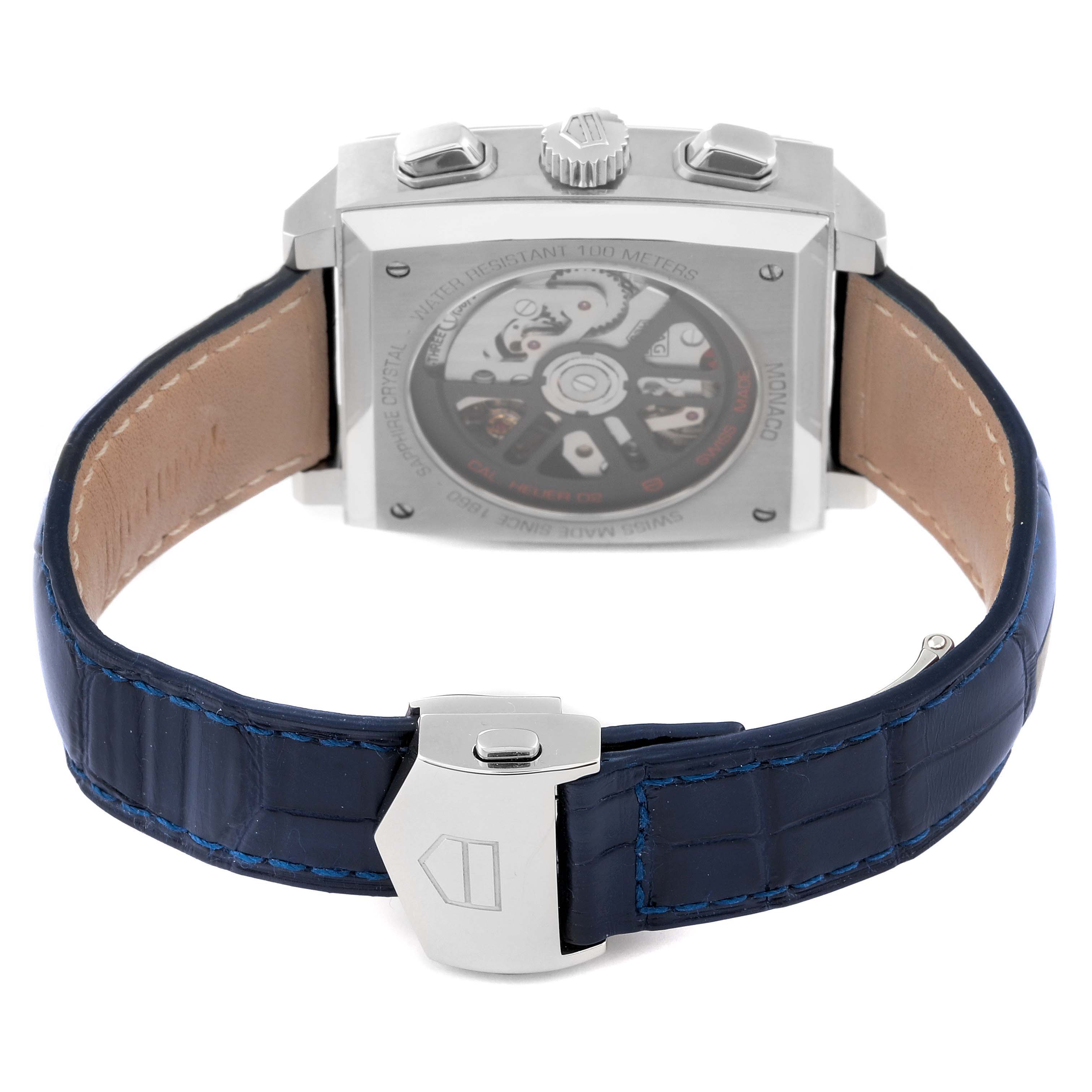 The image shows the back view of a Tag Heuer Monaco CBL2111.FC6453 Men's Stainless Steel Blue Dial CBL2111.FC6453 Men's Stainless Steel Blue Dial watch, featuring the case back, movement, crown, side push buttons, strap, and clasp.