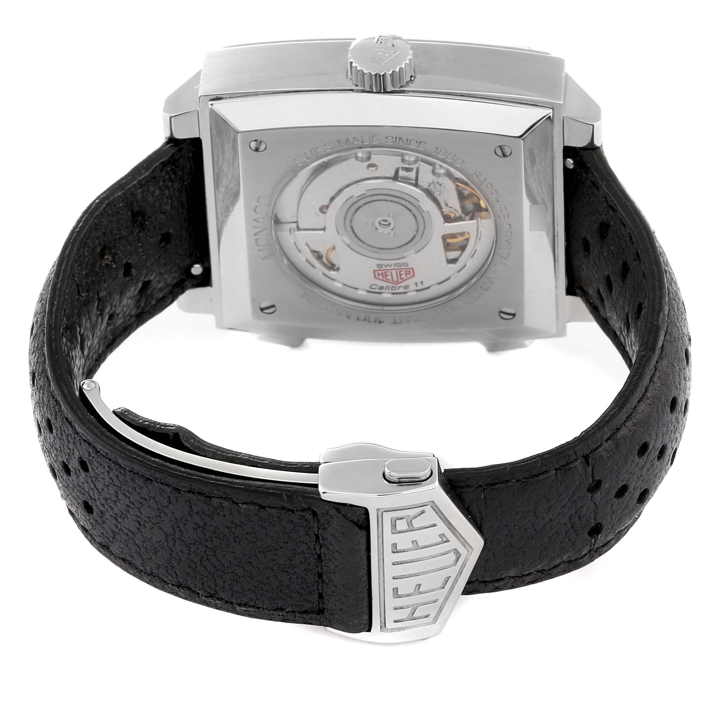 The image shows the back view of the Tag Heuer Monaco Limited Edition watch, featuring its movement and black leather strap with clasp.