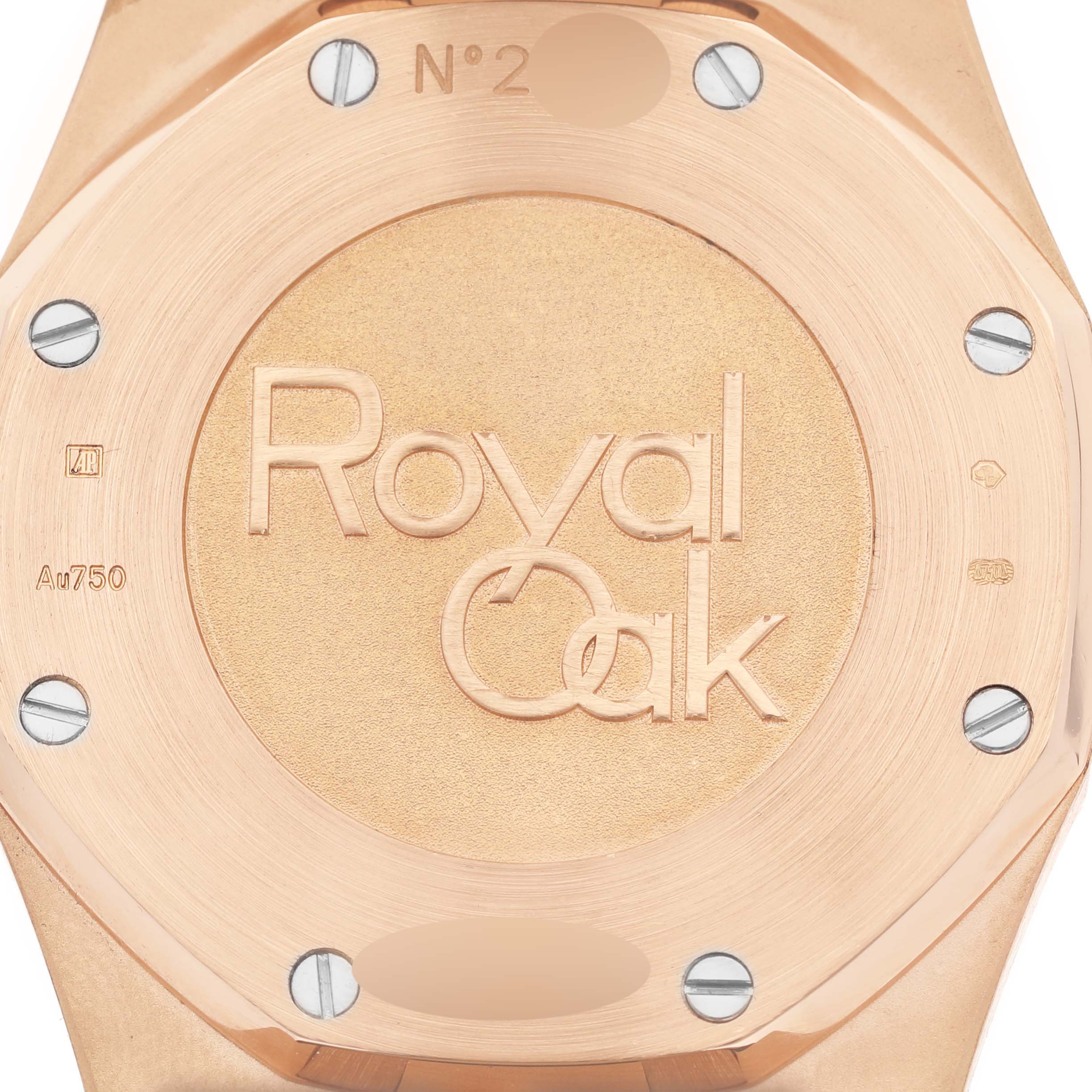 The image shows the back case of an Audemars Piguet Royal Oak 26120OR.OO.D088CR.01 Men's Rose Gold Silver Dial 26120OR.OO.D088CR.01 Men's Rose Gold Silver Dial watch, emphasizing the engraved logo and screw details.