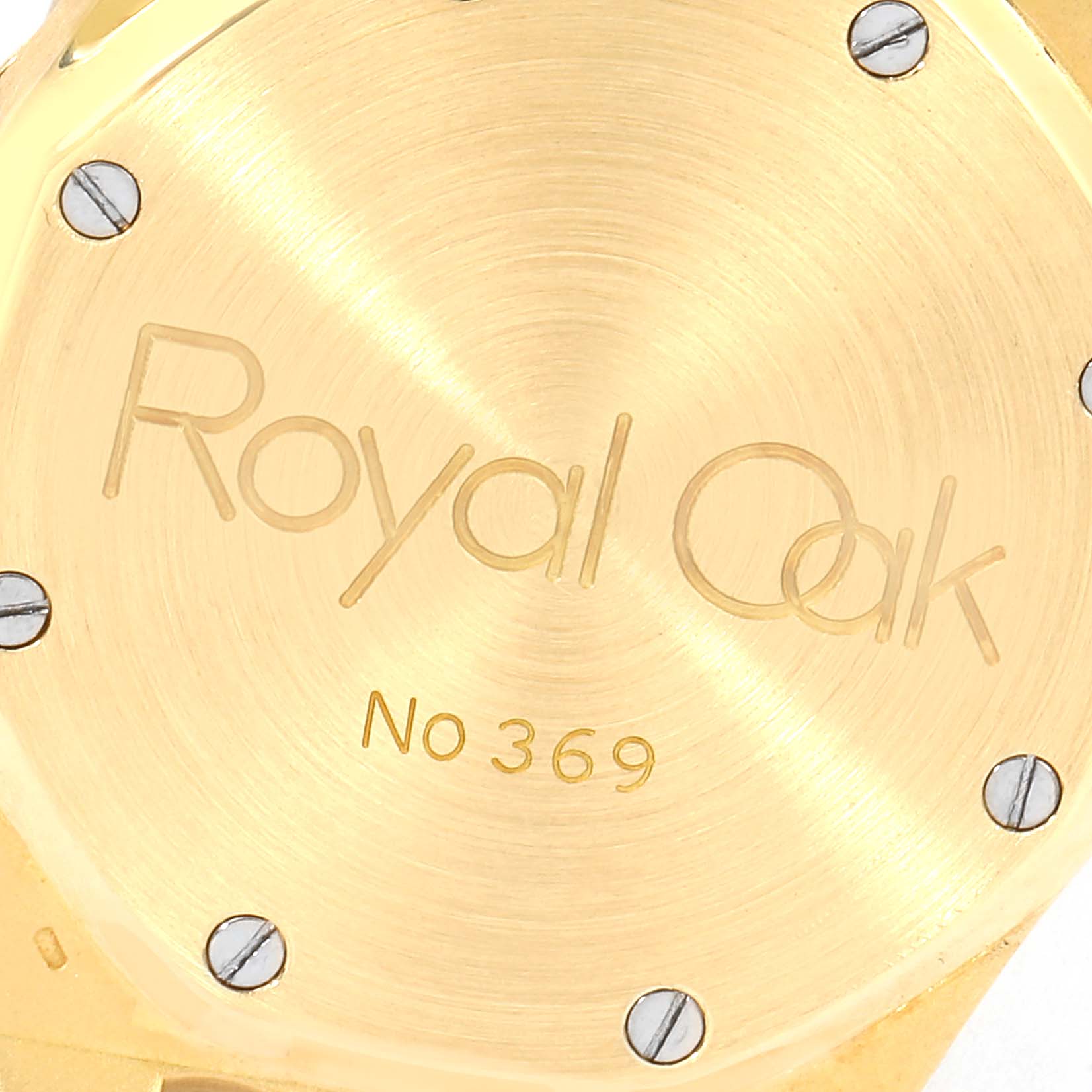 The image shows the case back of a Royal Oak model by Audemars Piguet, highlighting the model name and serial number.