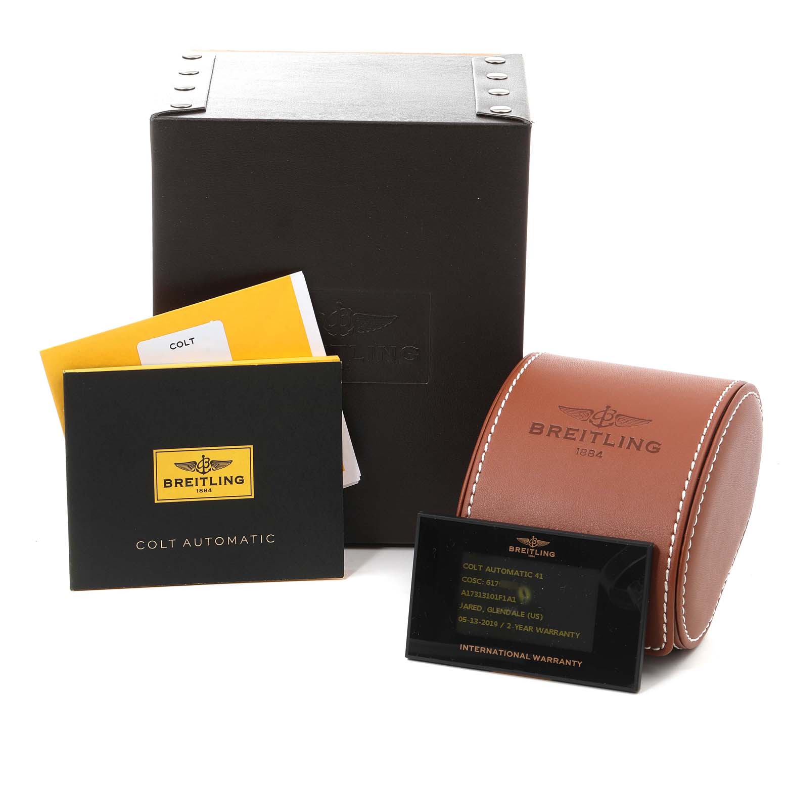 The image shows the Breitling Colt A17313 Men
s Stainless Steel Grey Dial A17313 Men
s Stainless Steel Grey Dial watch
s packaging, warranty card, instruction manuals, and a leather case, viewed from the front.