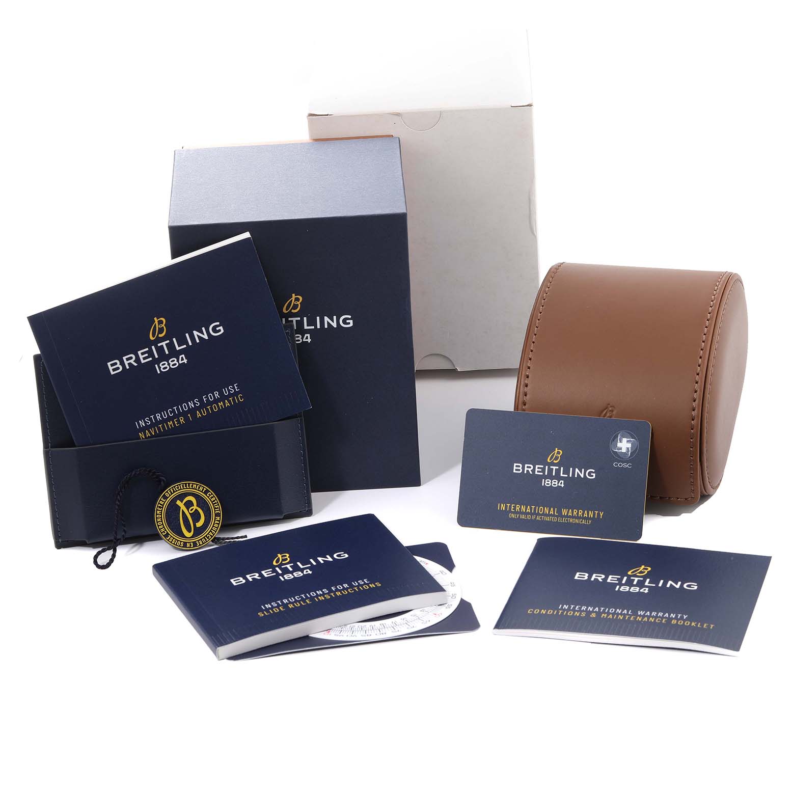 The image shows various accessories and documentation for the Breitling Navitimer A17325 Men's Stainless Steel Black Dial A17325 Men's Stainless Steel Black Dial, including manuals, warranty cards, and a wristwatch case.