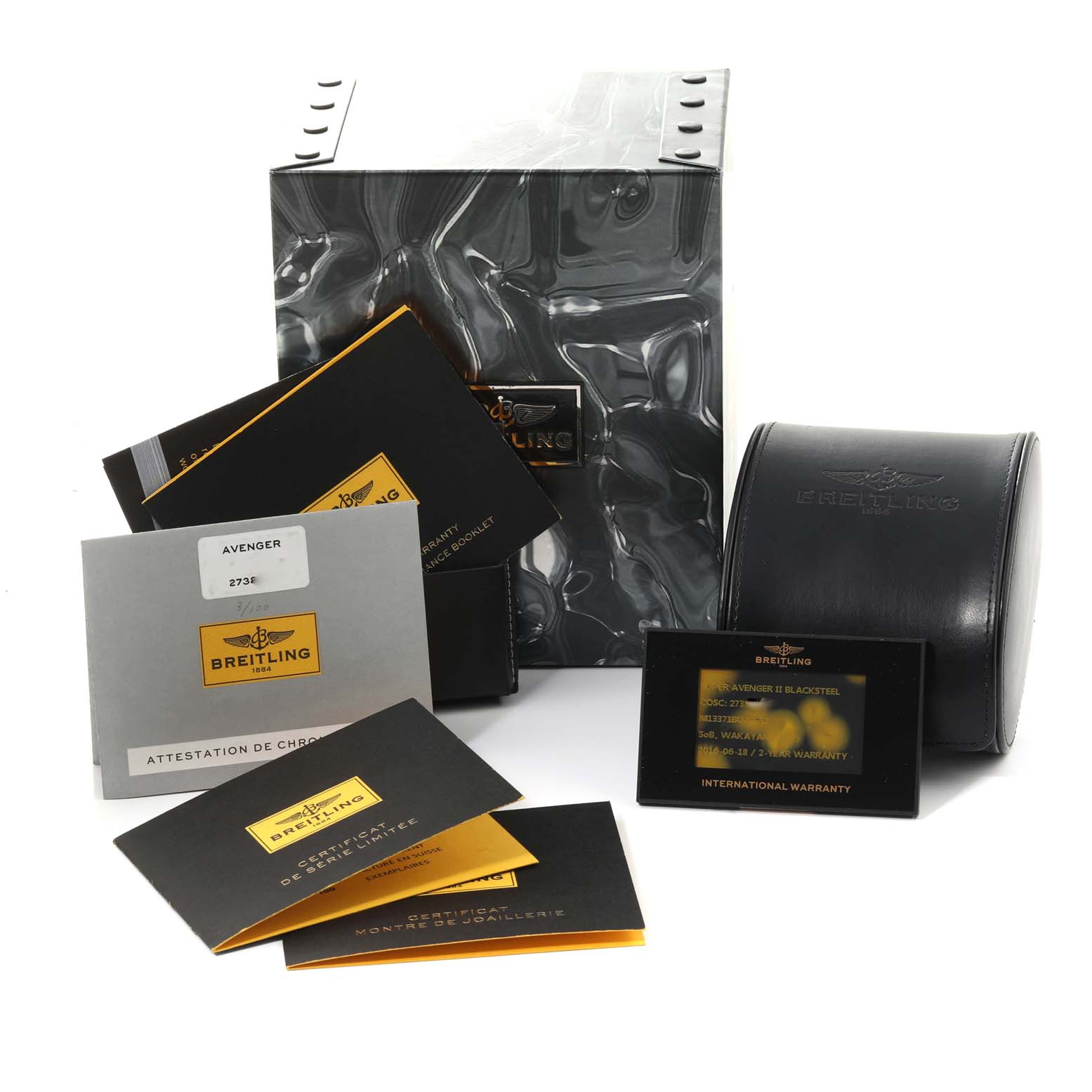 The image shows packaging and documents for a Breitling Avenger M13371BU/BE52 Men's Stainless Steel Mother of Pearl Dial M13371BU/BE52 Men's Stainless Steel Mother of Pearl Dial watch, including a box, warranty card, and certificates.