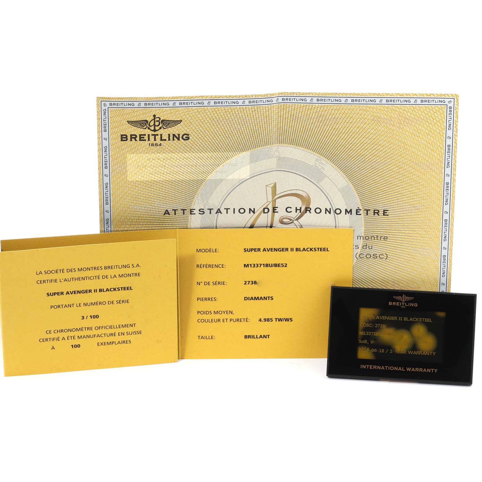 The image shows documentation and warranty cards for the Breitling Super Avenger II Blacksteel watch.