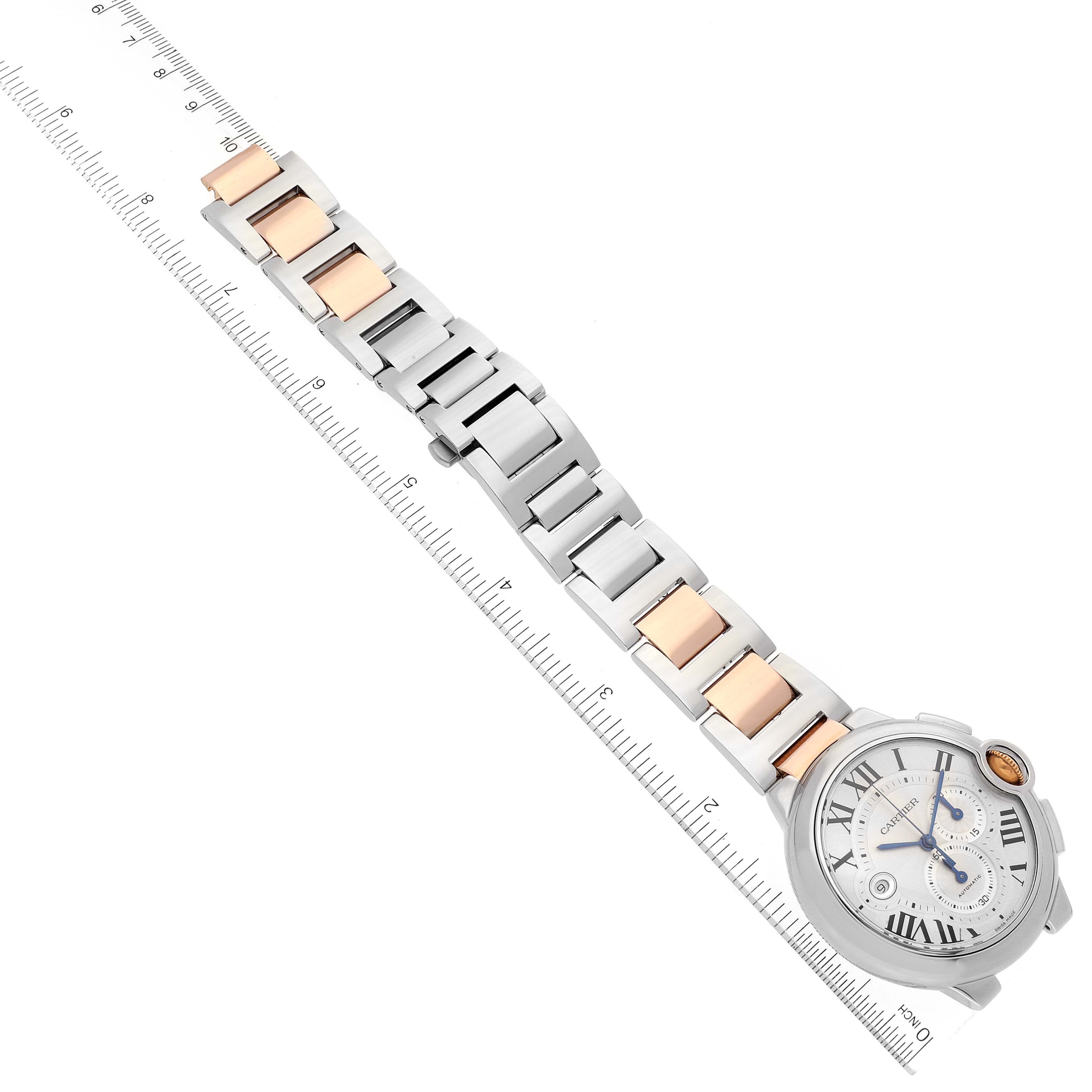The image shows the front view of a Ballon Bleu model by Cartier, displaying the watch dial and metal bracelet alongside a ruler for scale.