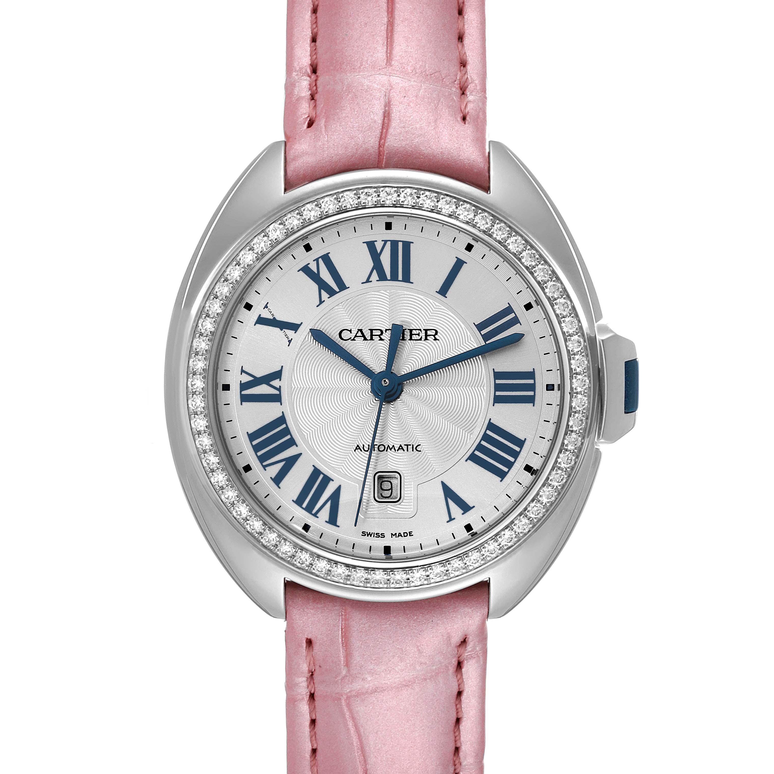 The image shows a Cartier Cle W4CL0005 Women's Stainless Steel Blue Dial W4CL0005 Women's Stainless Steel Blue Dial model watch from a front angle, featuring a pink strap and diamond-studded bezel.