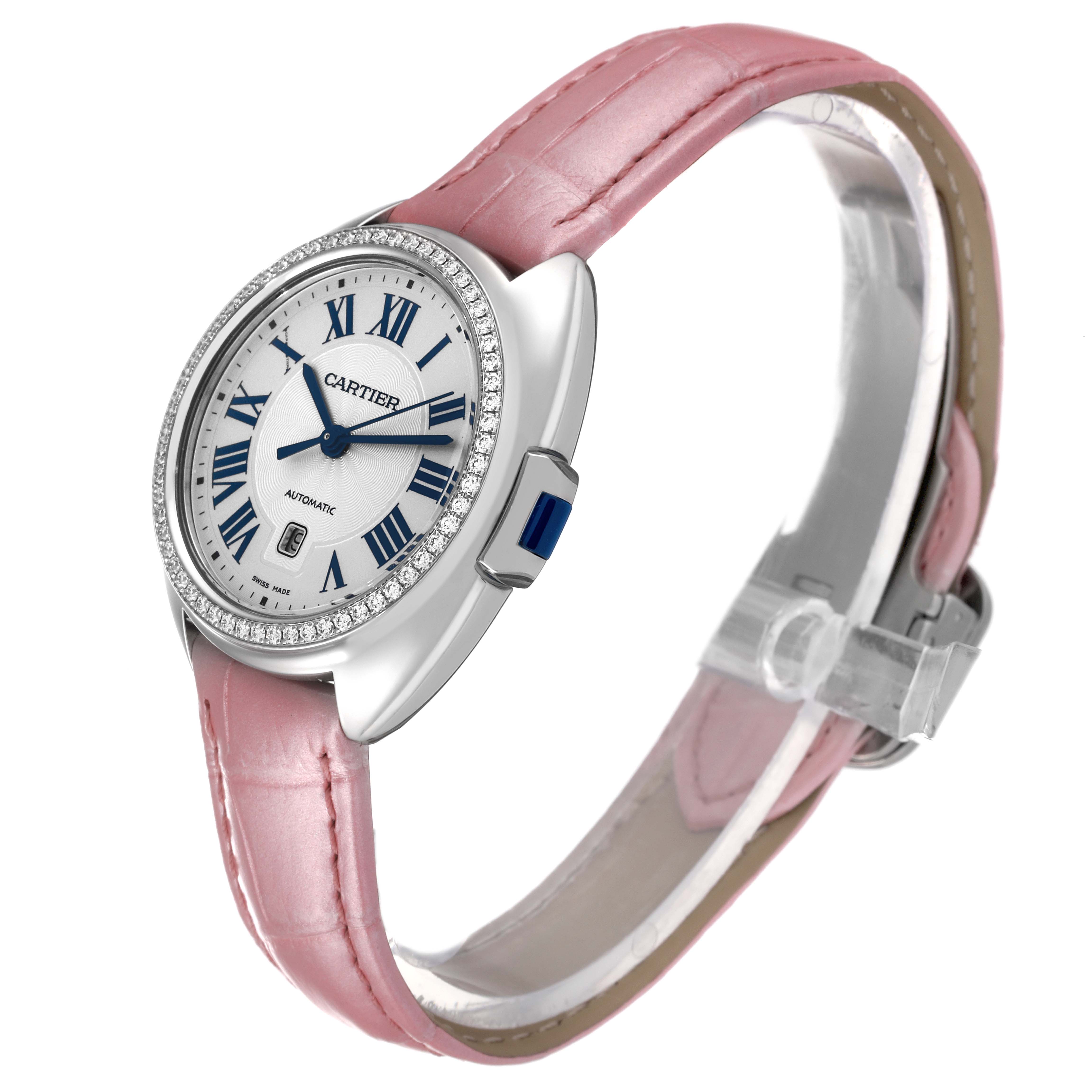 This image shows a side and front angle of the Cartier Cle W4CL0005 Women's Stainless Steel Blue Dial W4CL0005 Women's Stainless Steel Blue Dial model watch with a pink strap and diamond-studded bezel.