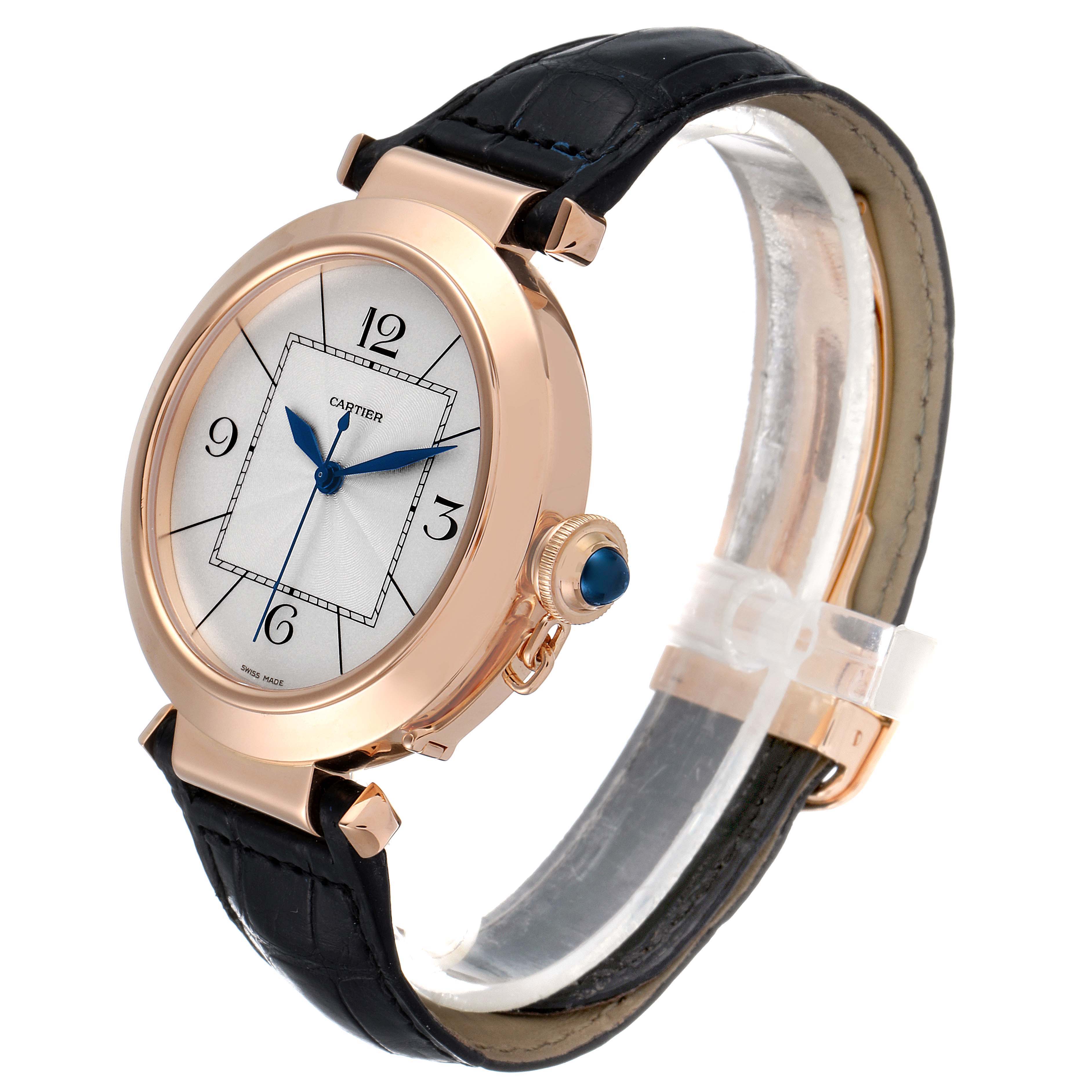 The Pasha model by Cartier is shown at an angle, highlighting the watch face, case, crown, and part of the leather strap.