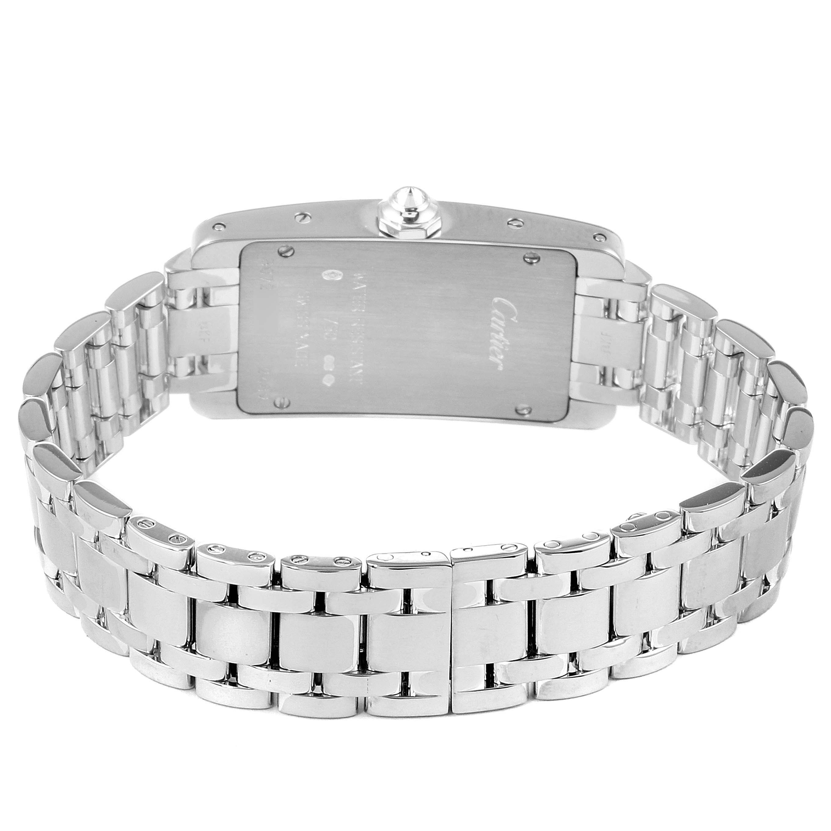 The image shows the back of the Tank Americaine watch by Cartier, featuring the case back and metal bracelet.