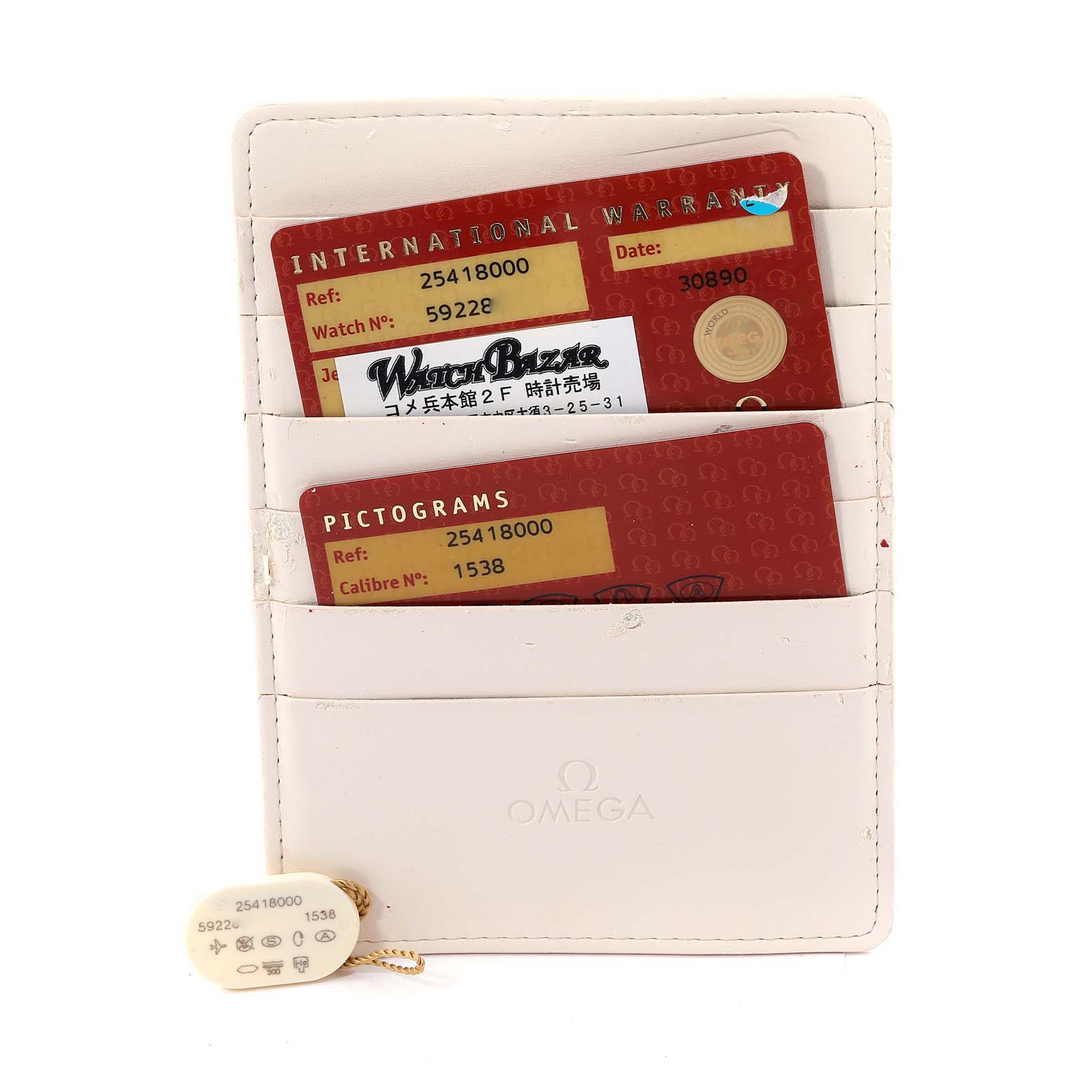 The image shows cards and a tag associated with the Omega Seamaster 2541.80.00 Men's Stainless Steel Blue Dial 2541.80.00 Men's Stainless Steel Blue Dial watch, including an international warranty and pictograms, displayed in a holder.