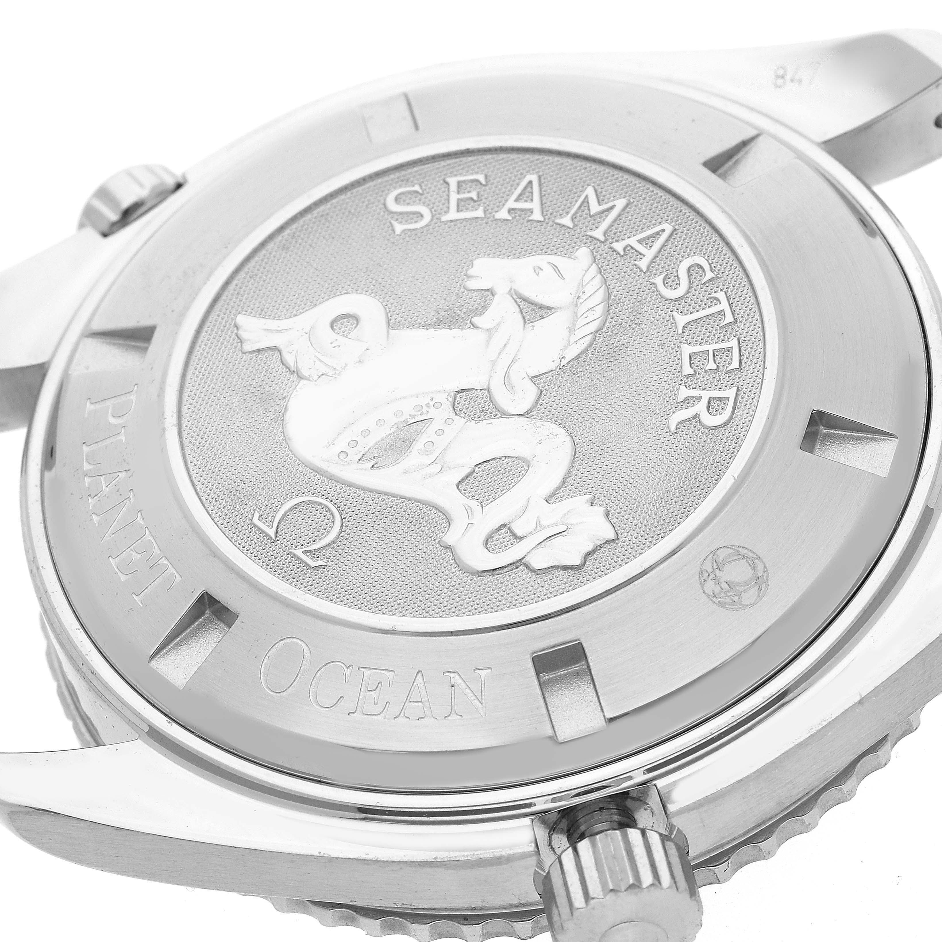 The image shows the case back and crown of an Omega Planet Ocean 2908.50.82 Men
s Stainless Steel Black Dial 2908.50.82 Men
s Stainless Steel Black Dial Seamaster watch angled from the side.