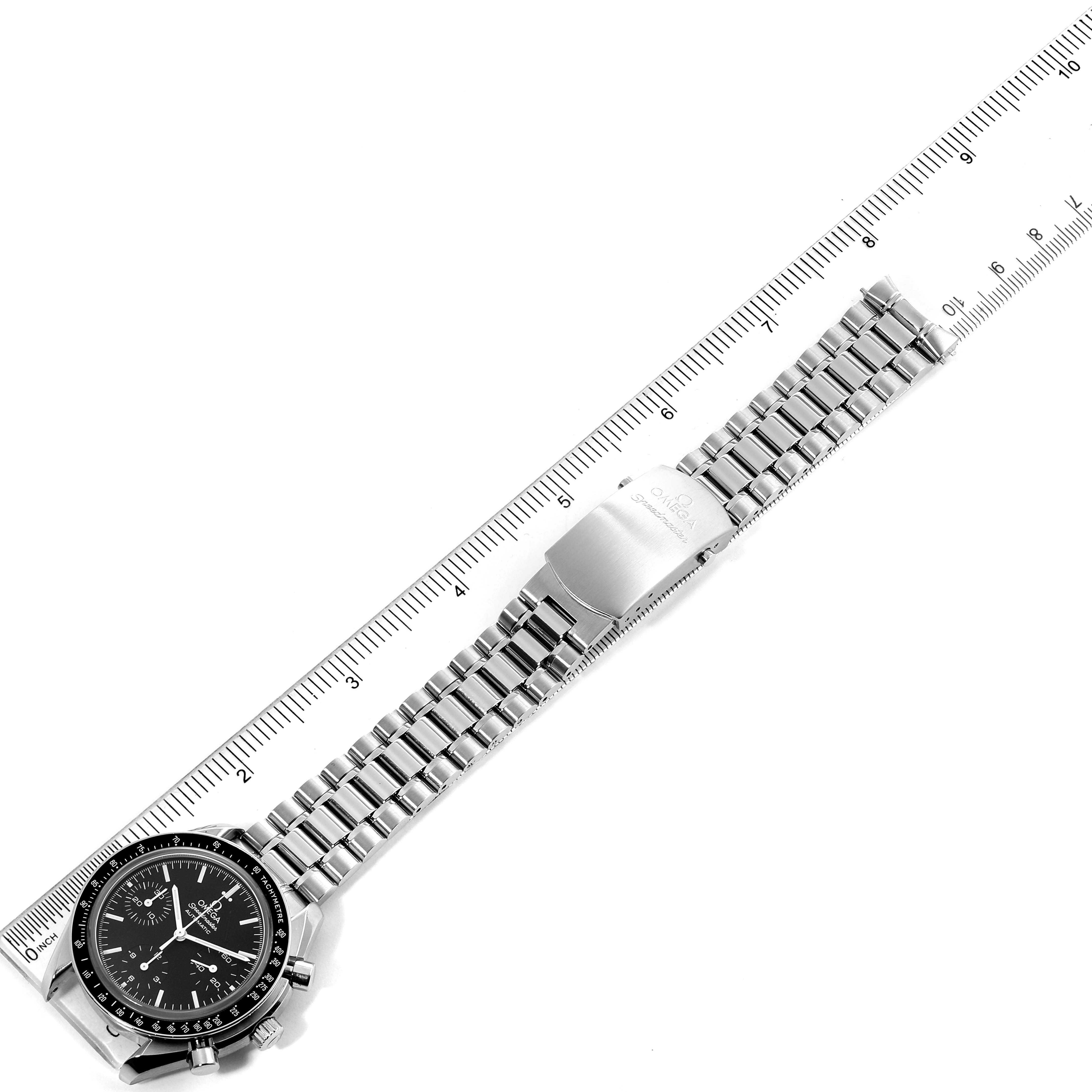 The image shows an Omega Speedmaster 3539.50.00 Men
s Stainless Steel Black Dial 3539.50.00 Men
s Stainless Steel Black Dial watch from a top-down angle, showcasing the watch face, bracelet, and clasp alongside a ruler.
