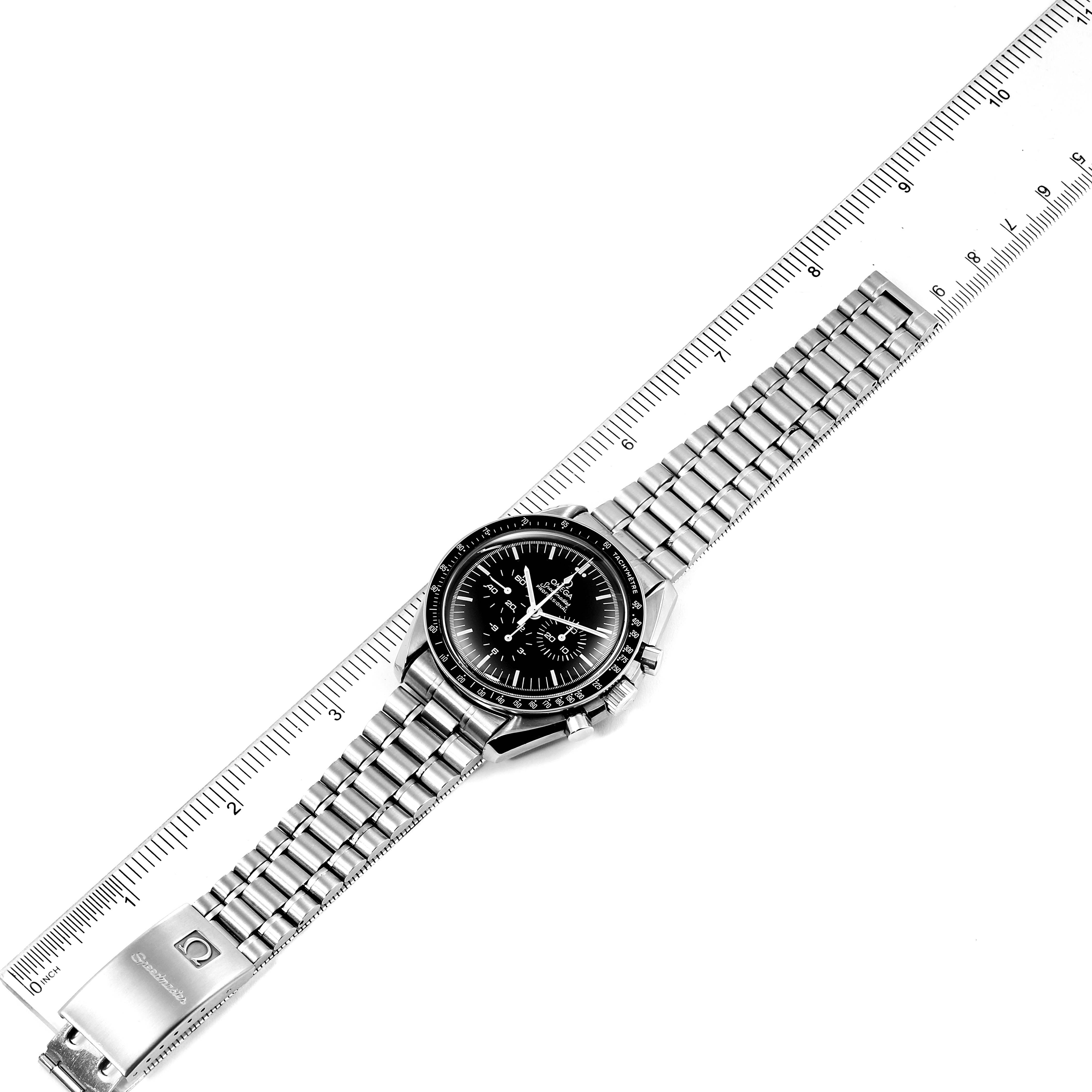 The Omega Speedmaster 145.022 Men's Stainless Steel Black Dial 145.022 Men's Stainless Steel Black Dial watch is shown from a top-down angle, fully extended next to a ruler.