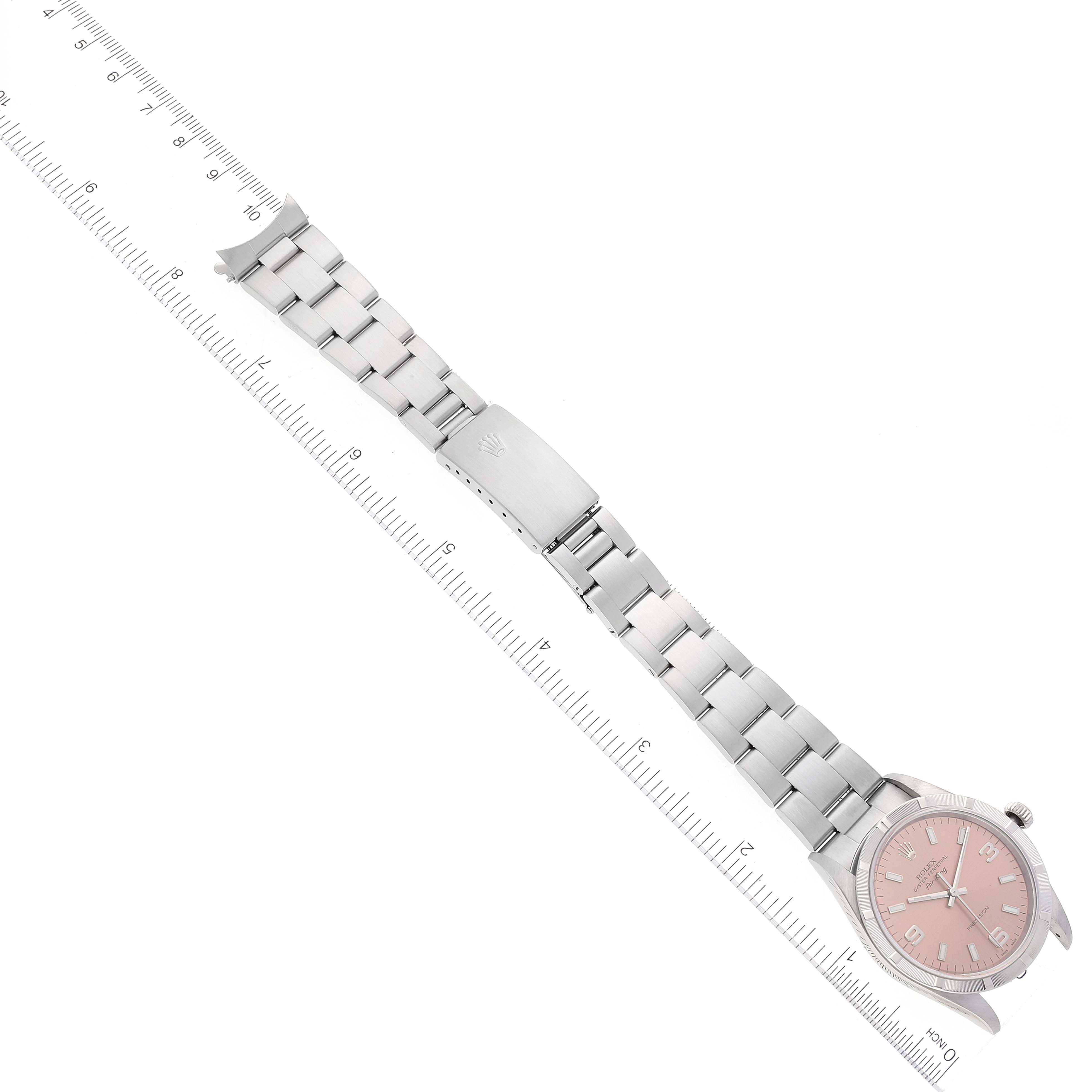 The image shows a Rolex Air-King 14010 Men's Stainless Steel Pink Dial 14010 Men's Stainless Steel Pink Dial watch laid flat from an angled perspective, displaying the face, band, and clasp with measurement rulers.