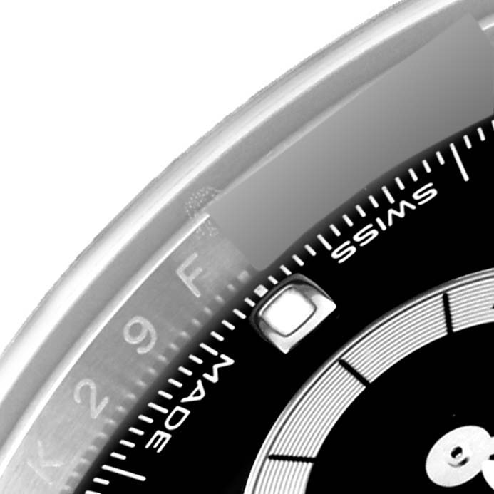 The image shows a close-up of a portion of the dial and bezel of a Rolex Daytona 116500LN Men's Stainless Steel Black Dial 116500LN Men's Stainless Steel Black Dial watch.