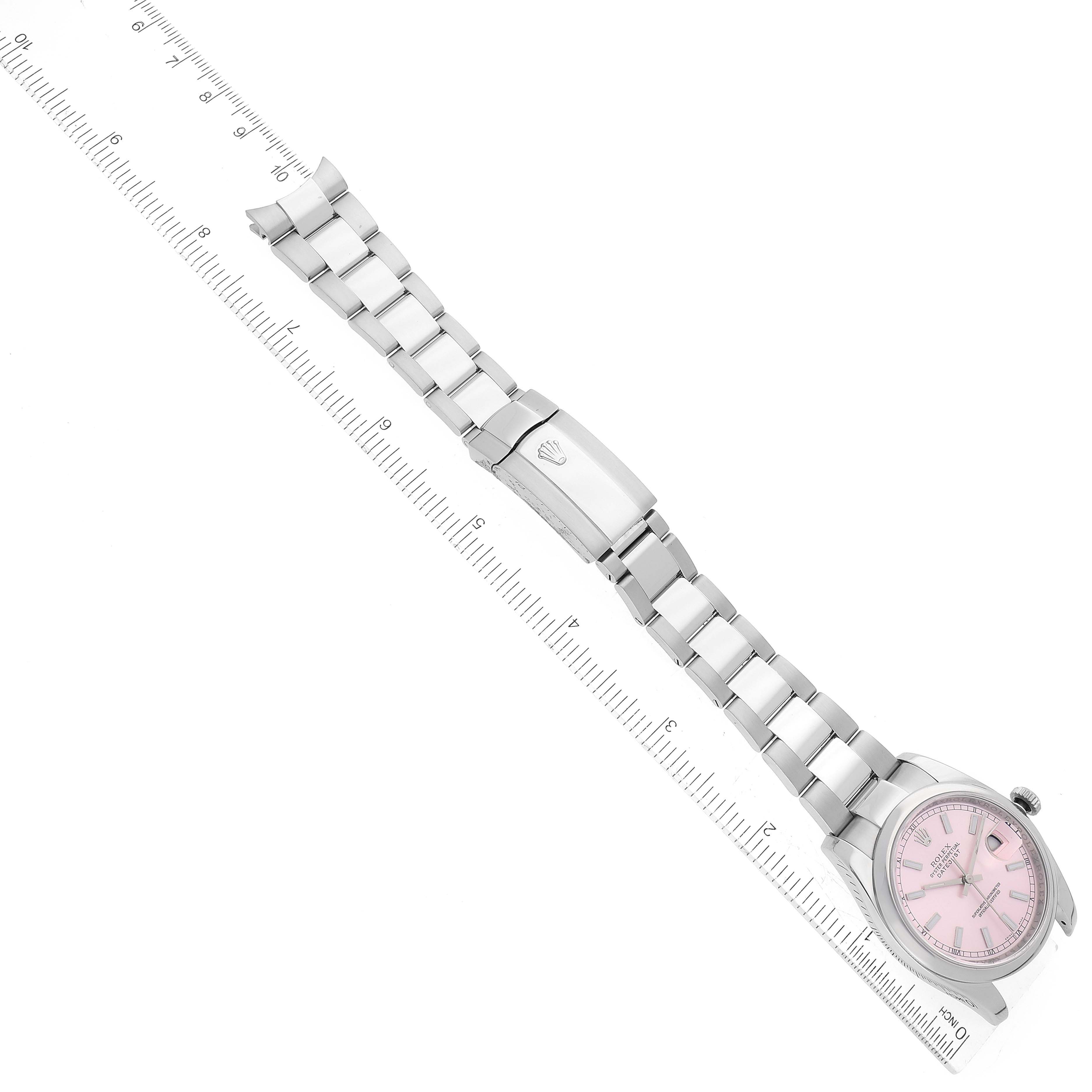 The image shows a Rolex Datejust 116200 Men's Stainless Steel Pink Dial 116200 Men's Stainless Steel Pink Dial watch laid flat with its bracelet extended beside a ruler.