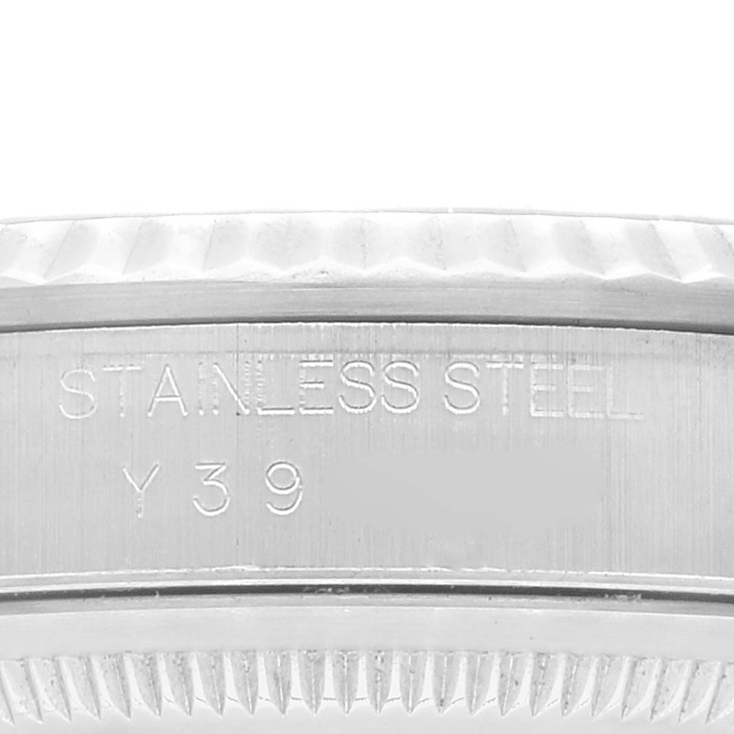 The image shows an angled view of the Rolex Datejust 16234 Men's Stainless Steel Black Dial 16234 Men's Stainless Steel Black Dial model's stainless steel watch case with serial and material engravings.