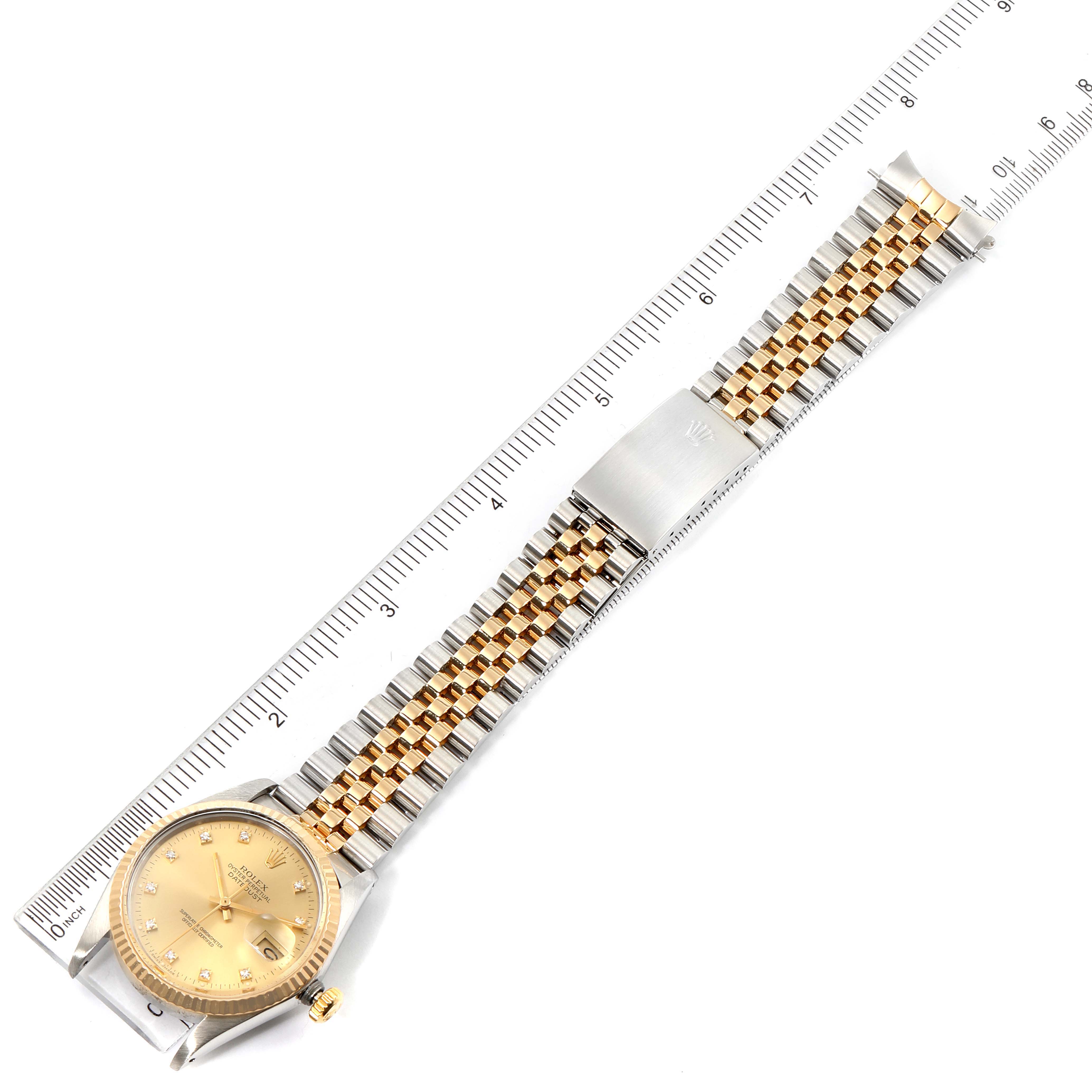 This is a top-down view of the Vintage Collection Rolex watch showing its dial, bezel, crown, and two-tone bracelet with a ruler for scale.