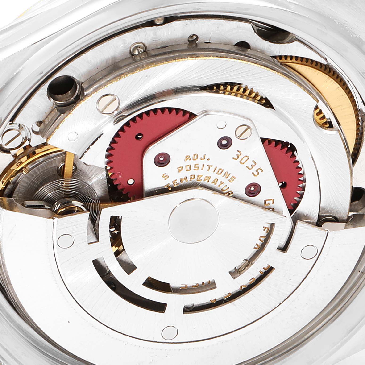 The image shows a close-up of the inner mechanical movement of the Vintage Collection Rolex watch, highlighting gears and components.