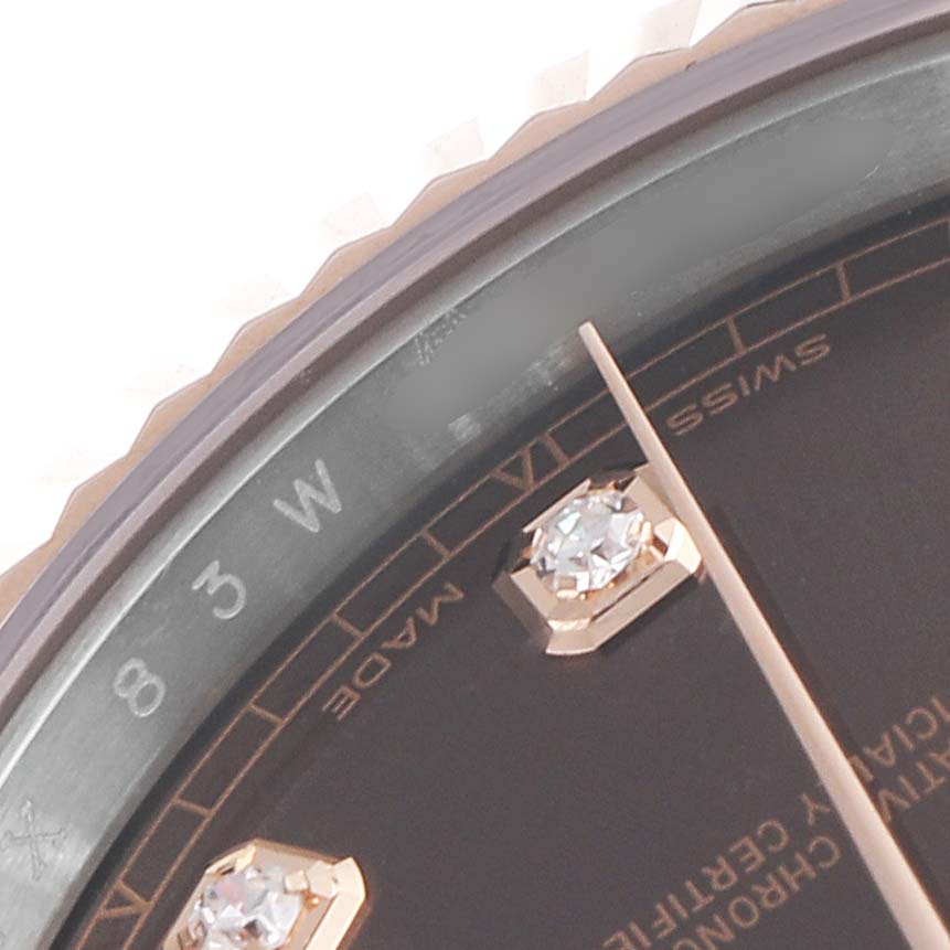 This close-up image shows the dial, diamond marker, minute hand, and part of the bezel of a Rolex Datejust 41 126331 Men's Steel and Gold (two tone) Brown Dial 126331 Men's Steel and Gold (two tone) Brown Dial model.