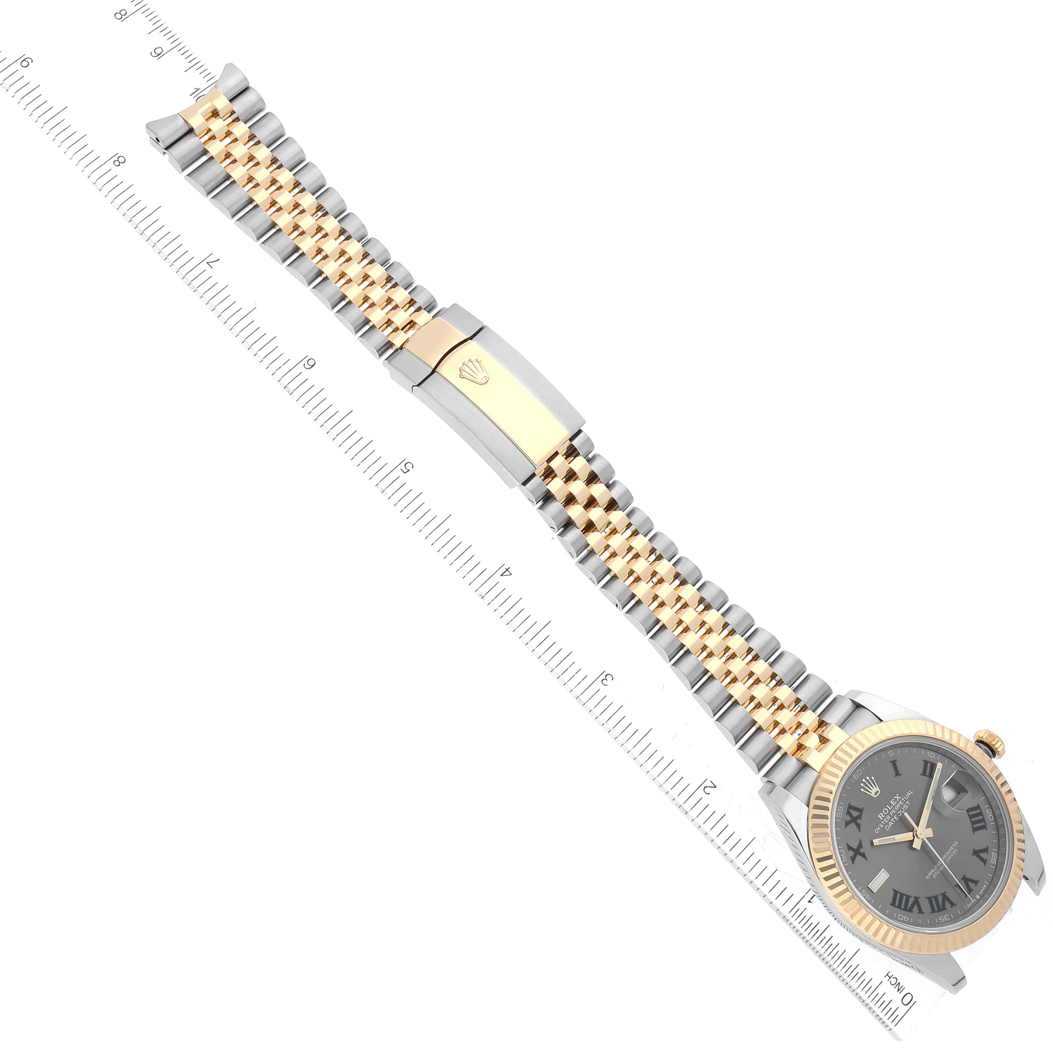 This image shows the Rolex Datejust 41 126333 Men's Steel and Gold (two tone) Grey Dial 126333 Men's Steel and Gold (two tone) Grey Dial watch laid flat with the face, full bracelet, and part of the clasp visible against a ruler.