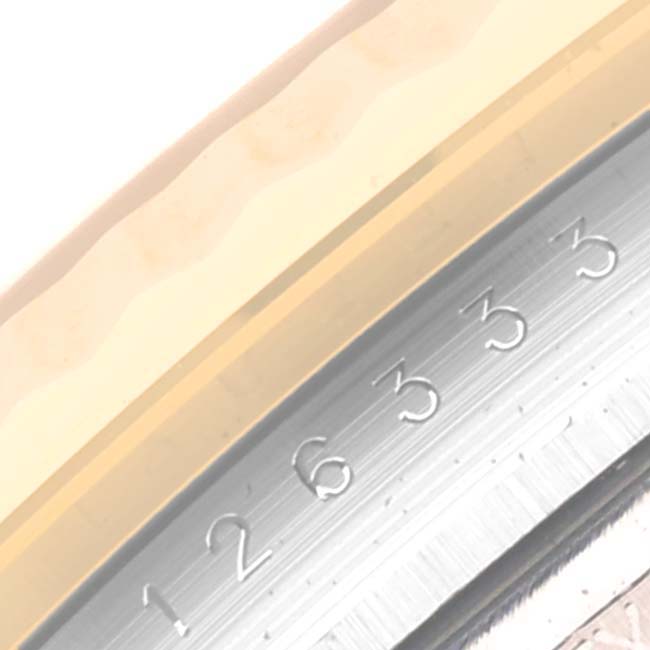 This image shows a close-up of the bezel and the rehaut with part of the serial number of a Rolex Datejust 41 126333 Men's Steel and Gold (two tone) Grey Dial 126333 Men's Steel and Gold (two tone) Grey Dial watch.