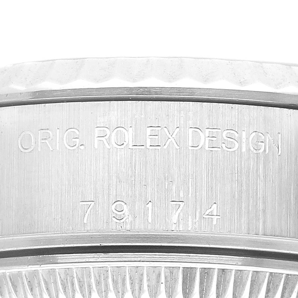 This close-up image shows the side engraving of a Rolex Datejust 79174 Women's Stainless Steel Blue Dial 79174 Women's Stainless Steel Blue Dial watch, featuring the text "ORIG. ROLEX DESIGN" and the model number "79174".