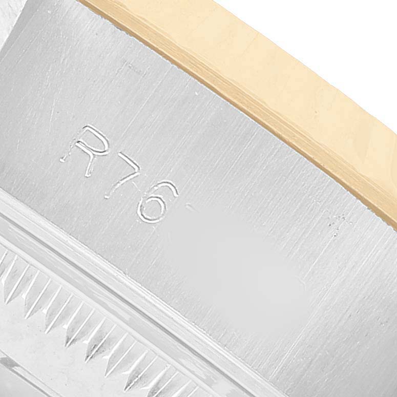 The image shows a close-up of the stainless steel edge and bezel serrations of a Rolex Datejust 69173 Women's Stainless Steel Champagne Dial watch.