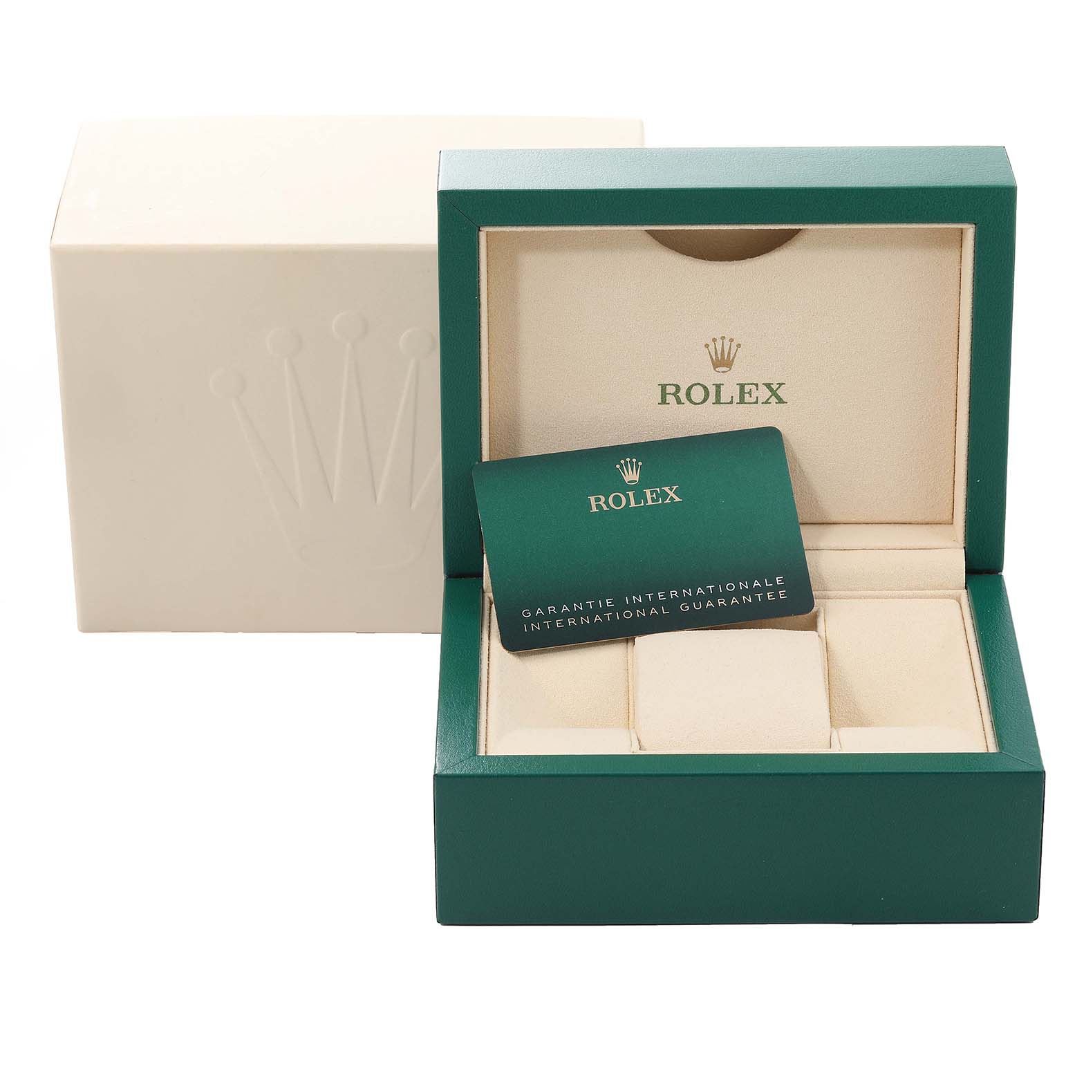This image shows a green Rolex watch box, an international guarantee card, and an outer cream-colored box, angled slightly from the front.