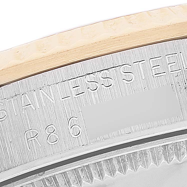 This close-up shows the caseback engraving and part of the bezel of a Rolex Mid-Size 68273 Women
s Steel and Gold (two tone) Champagne Dial 68273 Women
s Steel and Gold (two tone) Champagne Dial watch.