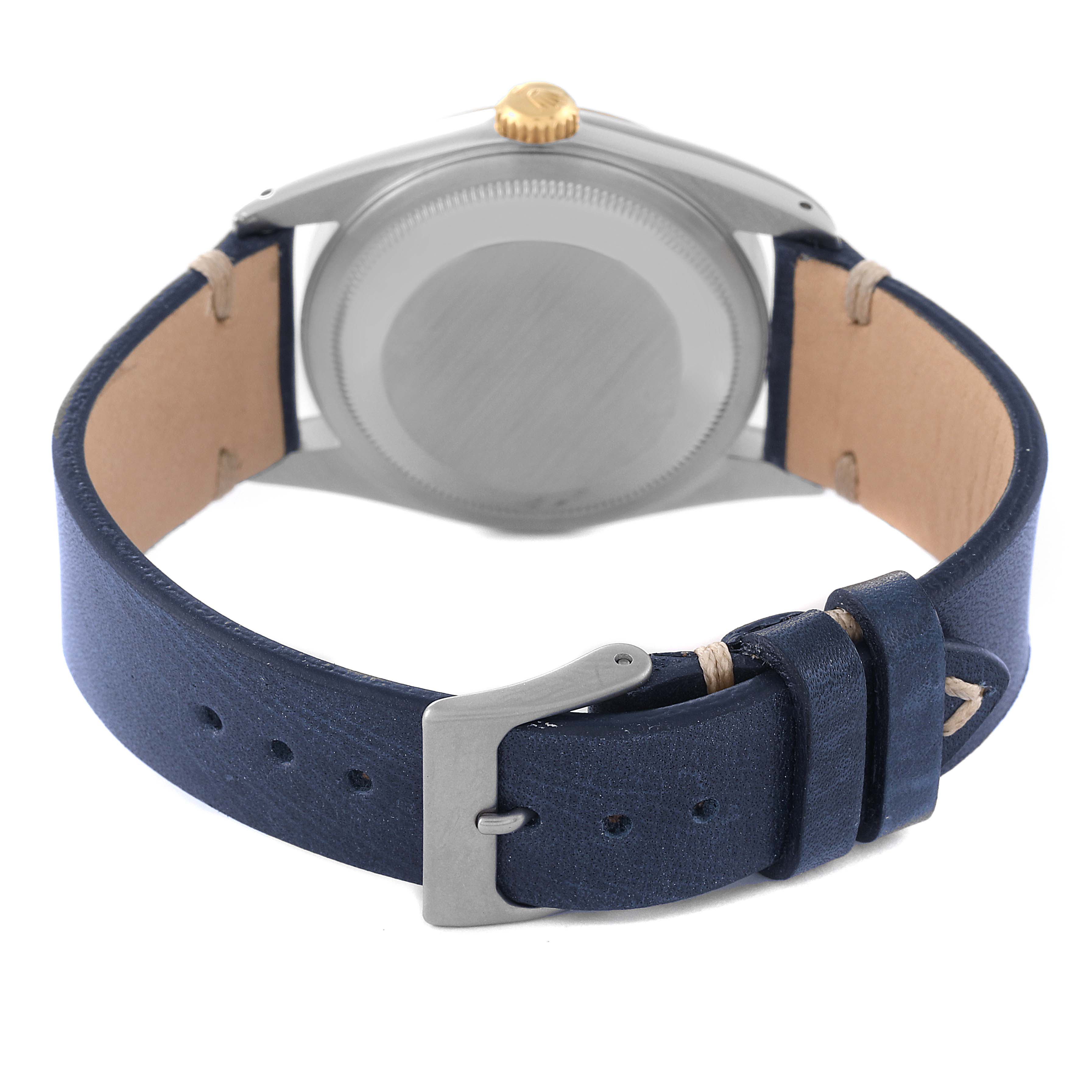 This image shows the back case and a blue leather strap of a Rolex Datejust 16233 Men's Steel and Gold (two tone) Champagne Dial 16233 Men's Steel and Gold (two tone) Champagne Dial watch.