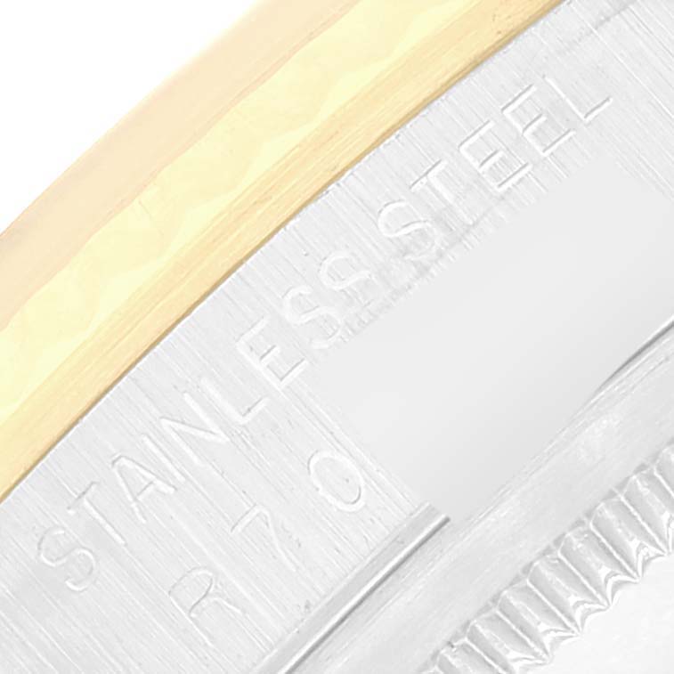 This image shows a close-up of the case back and part of the bezel on a Rolex Datejust 16233 Men's Steel and Gold (two tone) Champagne Dial 16233 Men's Steel and Gold (two tone) Champagne Dial model, highlighting the "Stainless Steel" engravings.