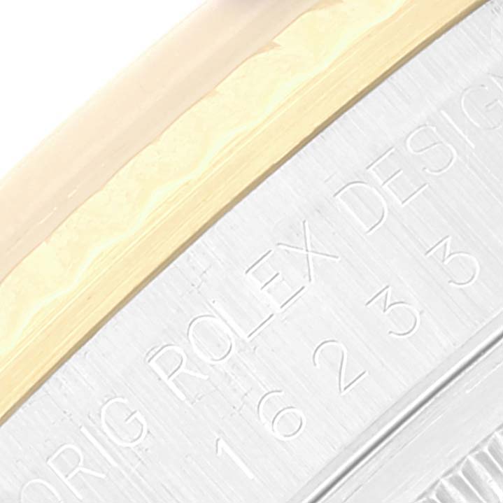 Close-up of the engraved casing edge on a Rolex Datejust 16233 Men's Steel and Gold (two tone) Champagne Dial 16233 Men's Steel and Gold (two tone) Champagne Dial watch.
