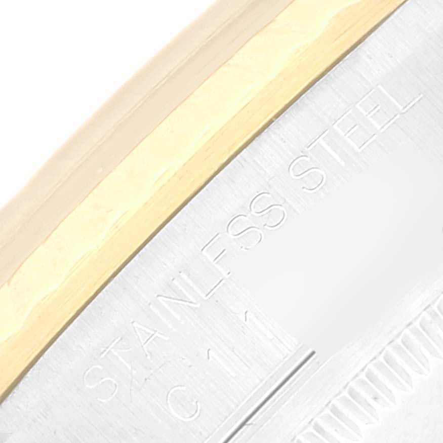 This image shows a close-up of a Rolex Datejust 16233 Men's Steel and Gold (two tone) Champagne Dial 16233 Men's Steel and Gold (two tone) Champagne Dial watch bezel with a partial view of the "Stainless Steel" inscription.