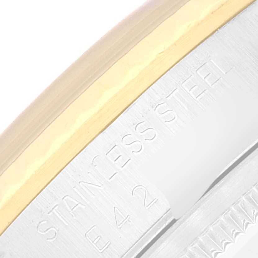 The image shows a close-up of the side of a Rolex Datejust 16233 Men's Steel and Gold (two tone) Champagne Dial 16233 Men's Steel and Gold (two tone) Champagne Dial watch, highlighting the stainless steel and gold parts.